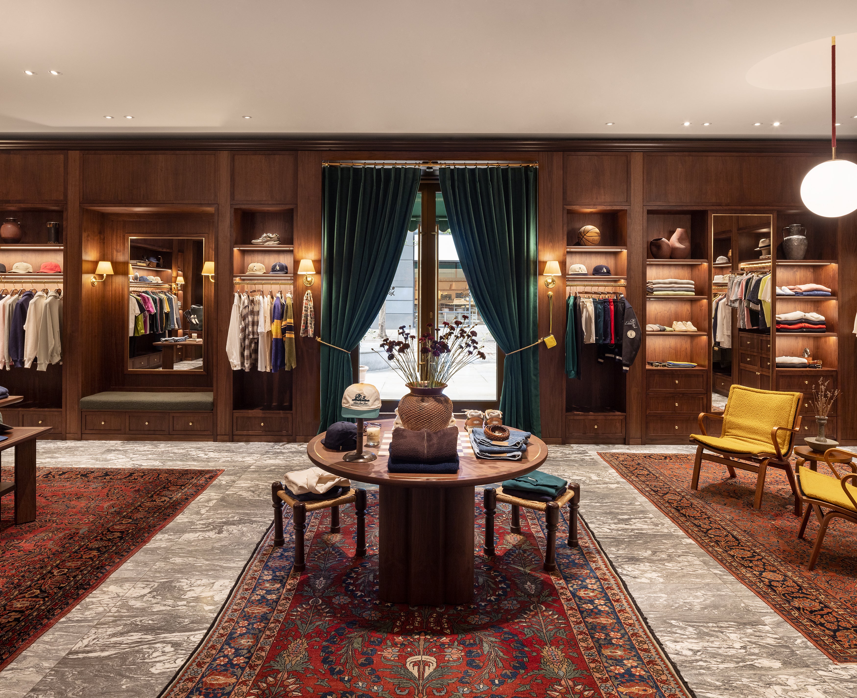 Center table with clothing and accessories at interior of London flagship