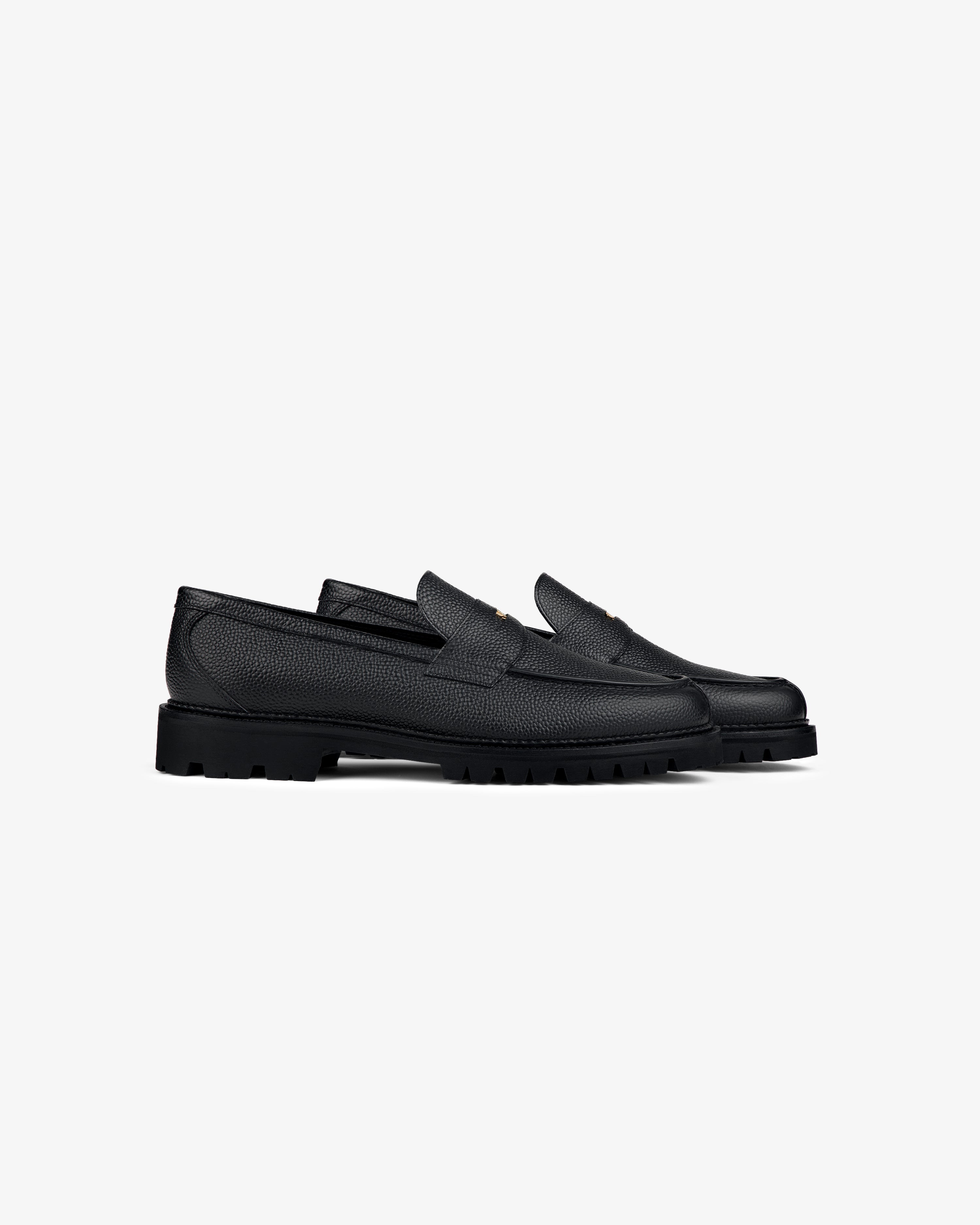 Lug Sole Queens Crest Loafers with textured black leather and chunky soles, shown side by side on a white background.