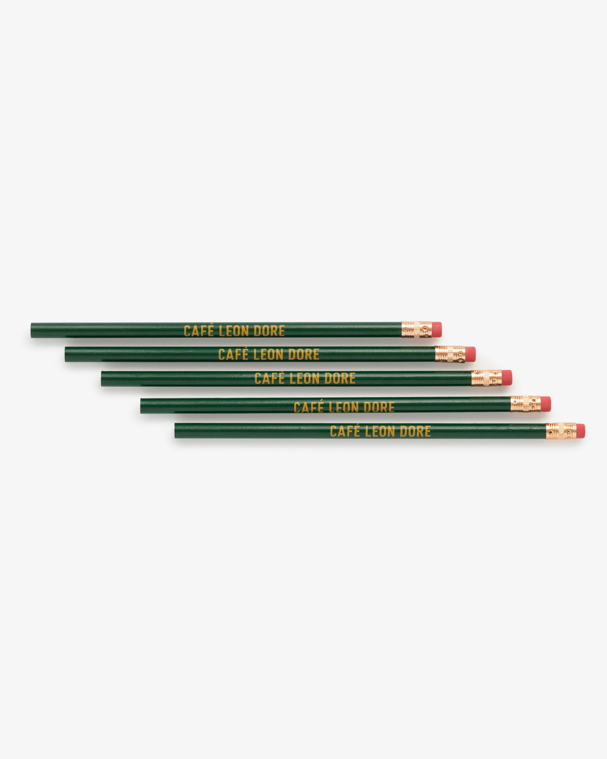 Five green Café Leon Dore pencils with erasers, each labeled in yellow, arranged in a row.