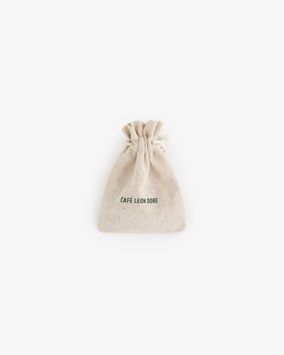 A small beige drawstring pouch for Café Leon Dore Komboloi, with branding on the front, centered on a white background.