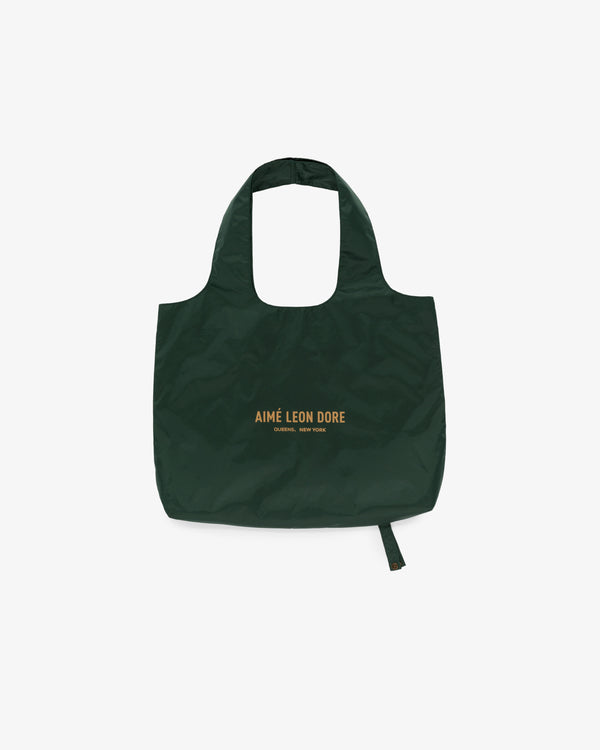 Dark green Packable Tote with yellow AIMÉ LEON DORE text on front, displayed against a white background.
