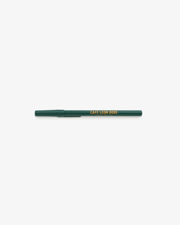 A green Café Leon Dore Ballpoint Pen with a yellow logo and cap, shown on a white background.