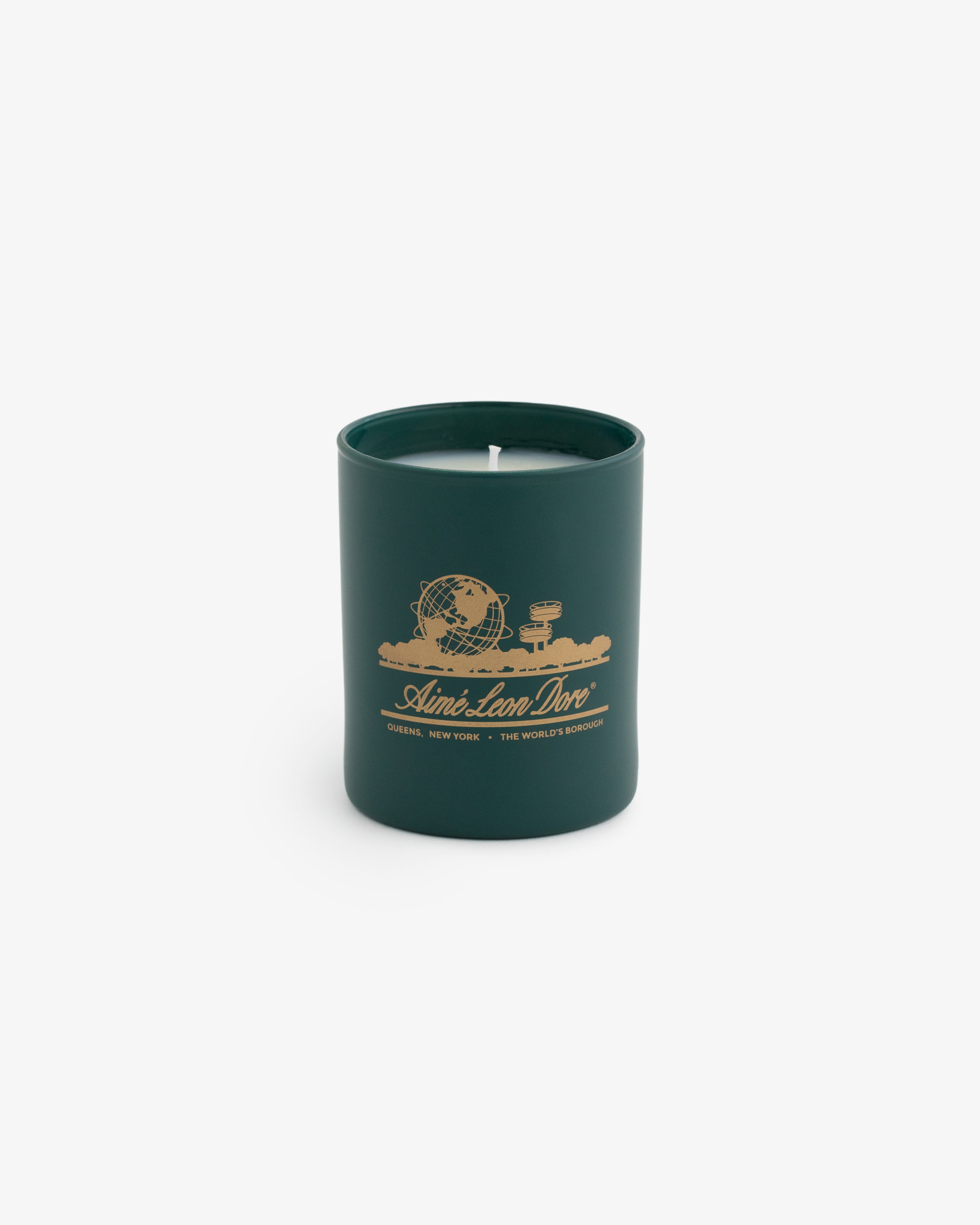 Unisphere Candle in matte glass holder with gold globe and text design, shown on a plain white background.