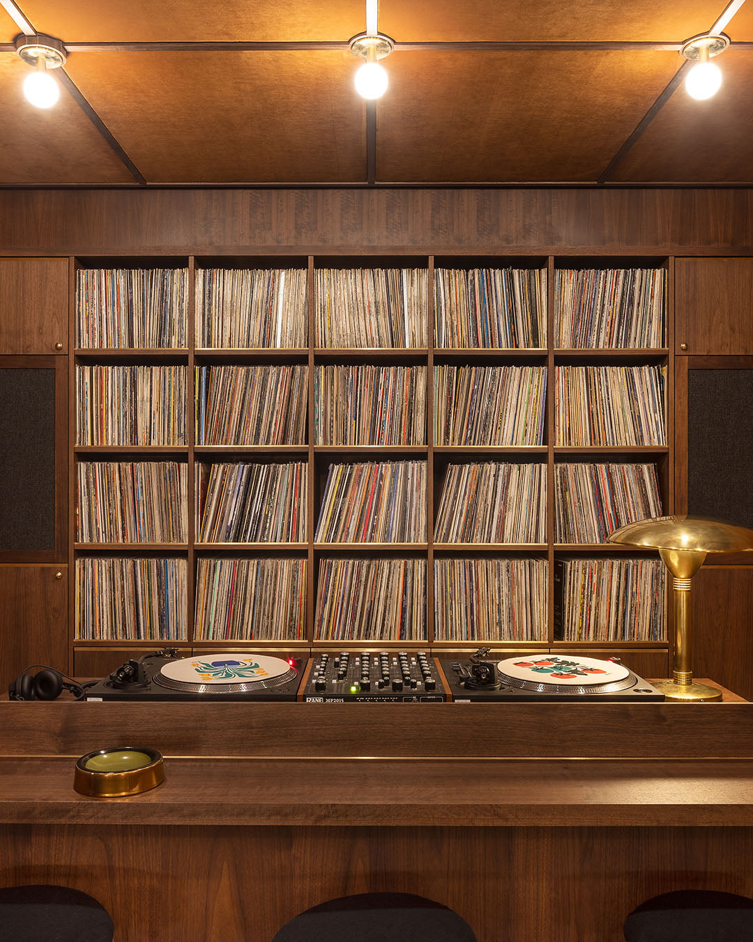 DJ area with shelf of records in back in Sound Room at London Flagship