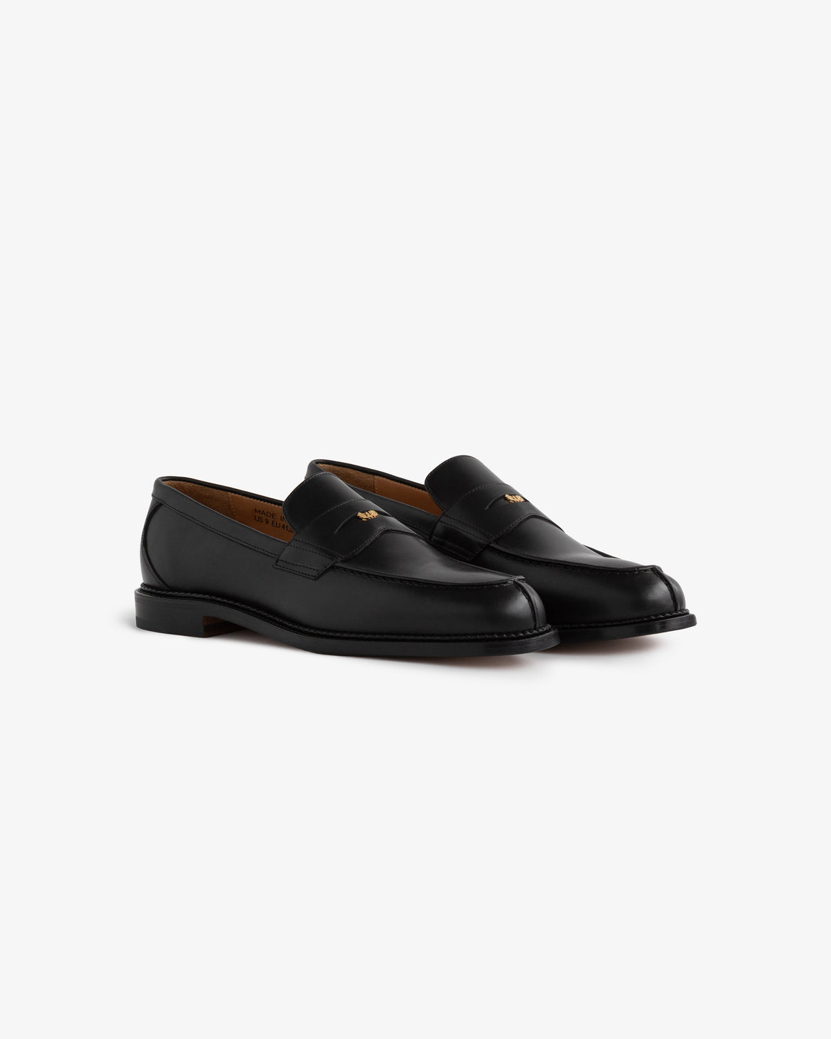 Queens Crest Loafer: black leather loafers with low heels and stitching details, shown on a white background.