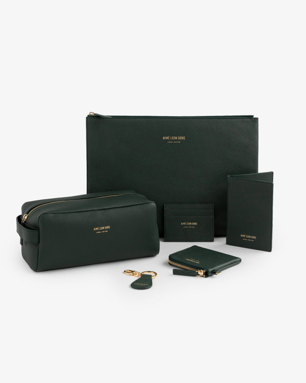 A green leather passport holder displayed on a white background.