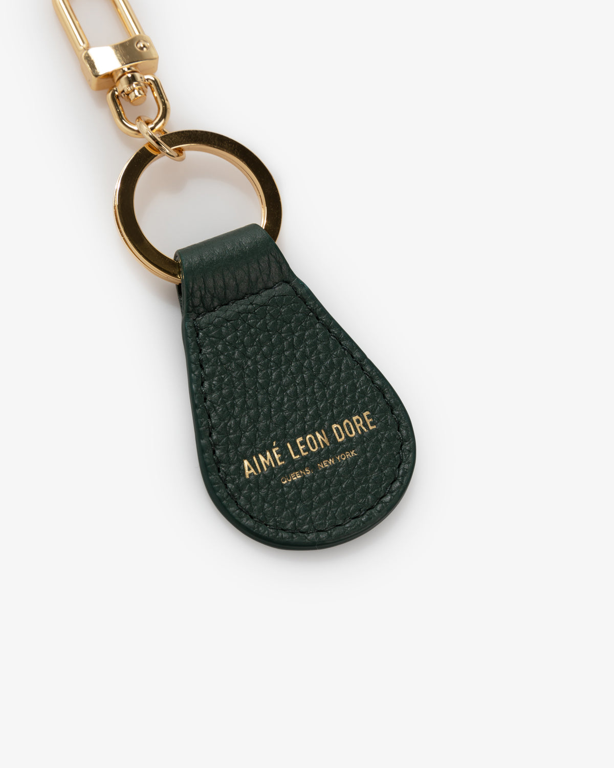 Dark green Leather Key Fob with gold hardware and AIMÉ LEON DORE embossed in gold.