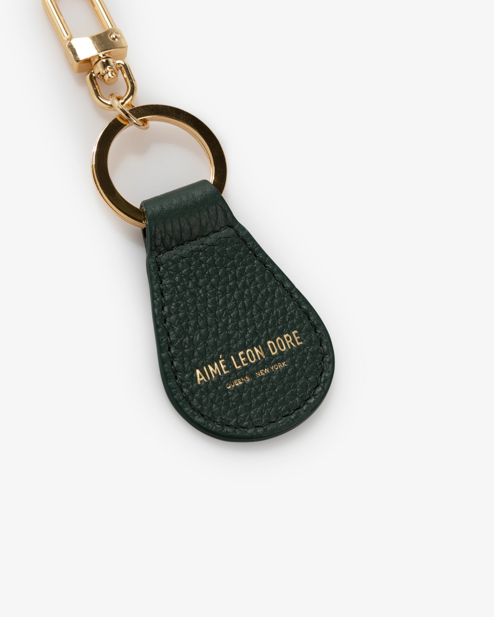 Dark green Leather Key Fob with gold hardware and AIMÉ LEON DORE embossed in gold.