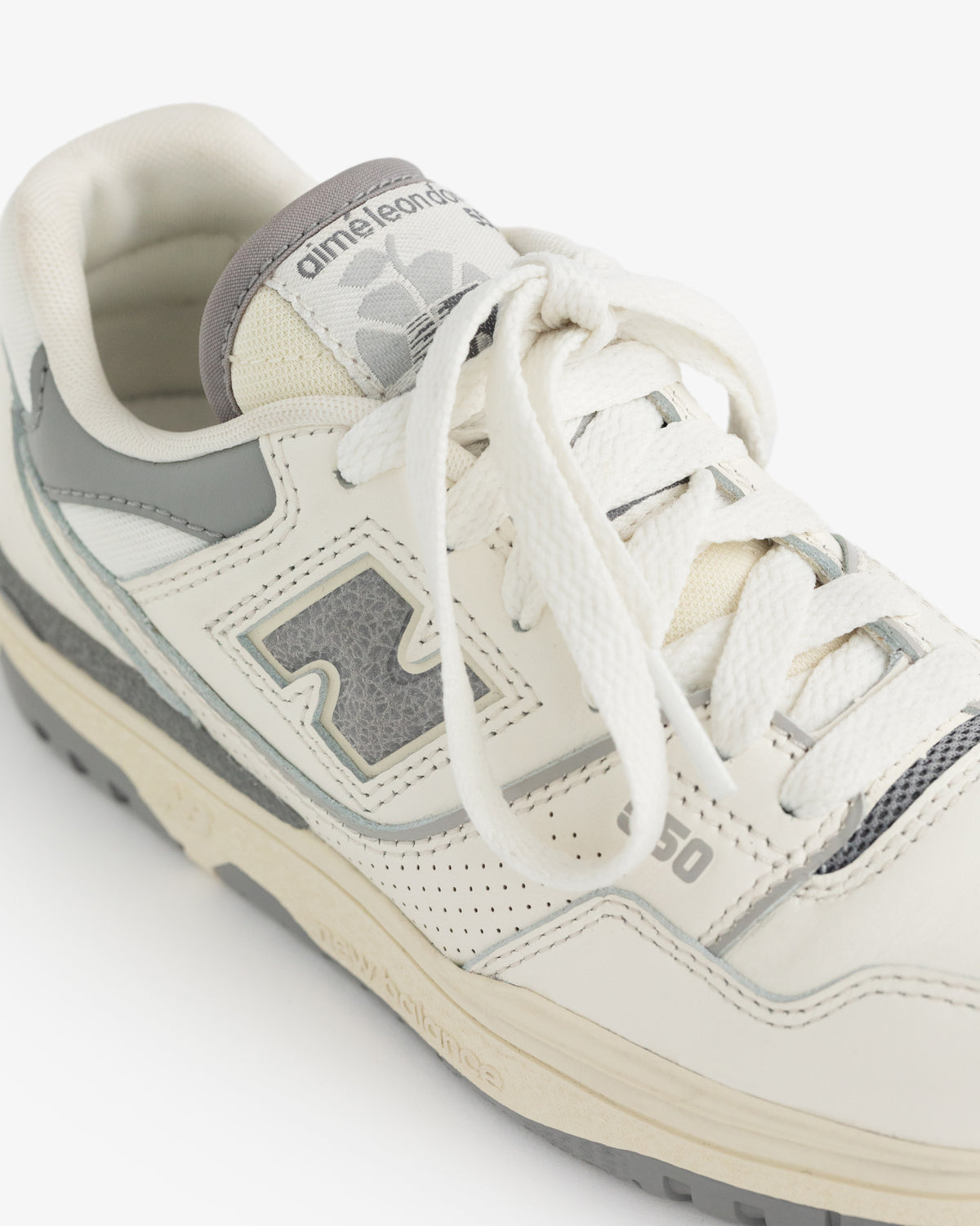 Off-white and grey ALD / NB P550 Basketball Oxfords for kids with Aime Leon Dore branding on the tongue and side.