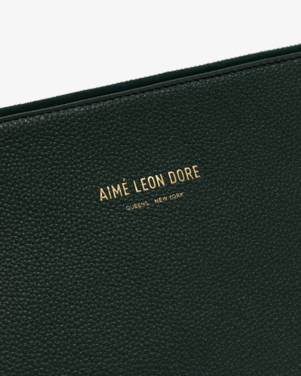 Close-up of Medium Leather Pouch in black textured leather with gold text: AIMÉ LEON DORE QUEENS, NEW YORK.