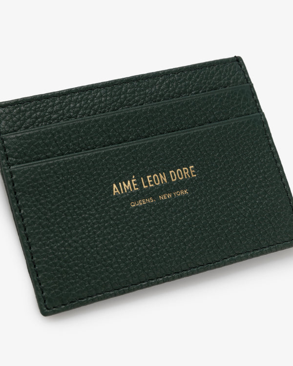 Dark green Leather Card Holder with gold AIMÉ LEON DORE QUEENS, NEW YORK text and three card slots.