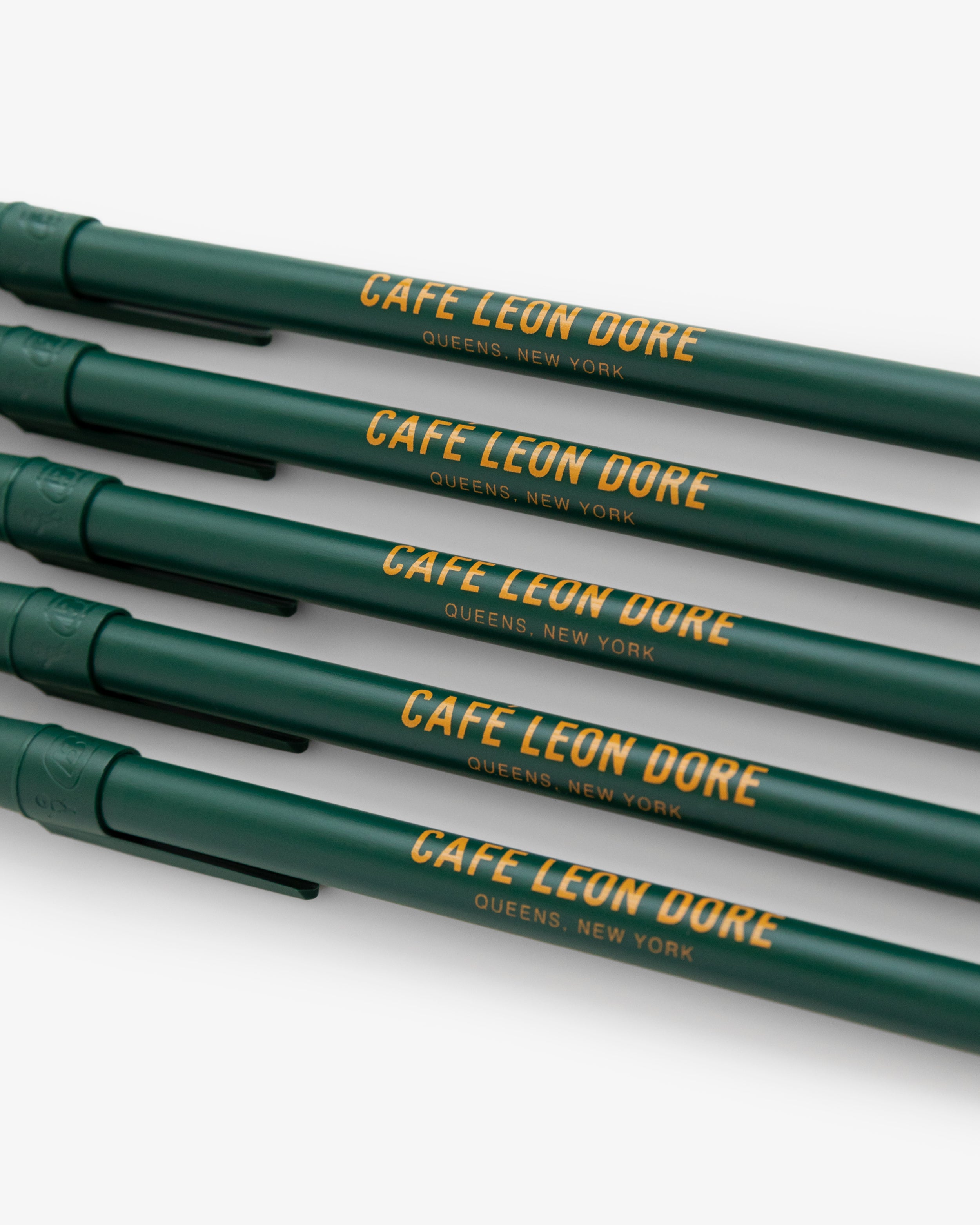 Café Leon Dore Ballpoint Pen Pack: Four green pens with QUEENS, NEW YORK in yellow on each barrel.