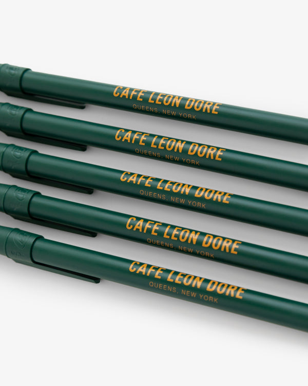 Café Leon Dore Ballpoint Pen Pack: Four green pens with QUEENS, NEW YORK in yellow on each barrel.