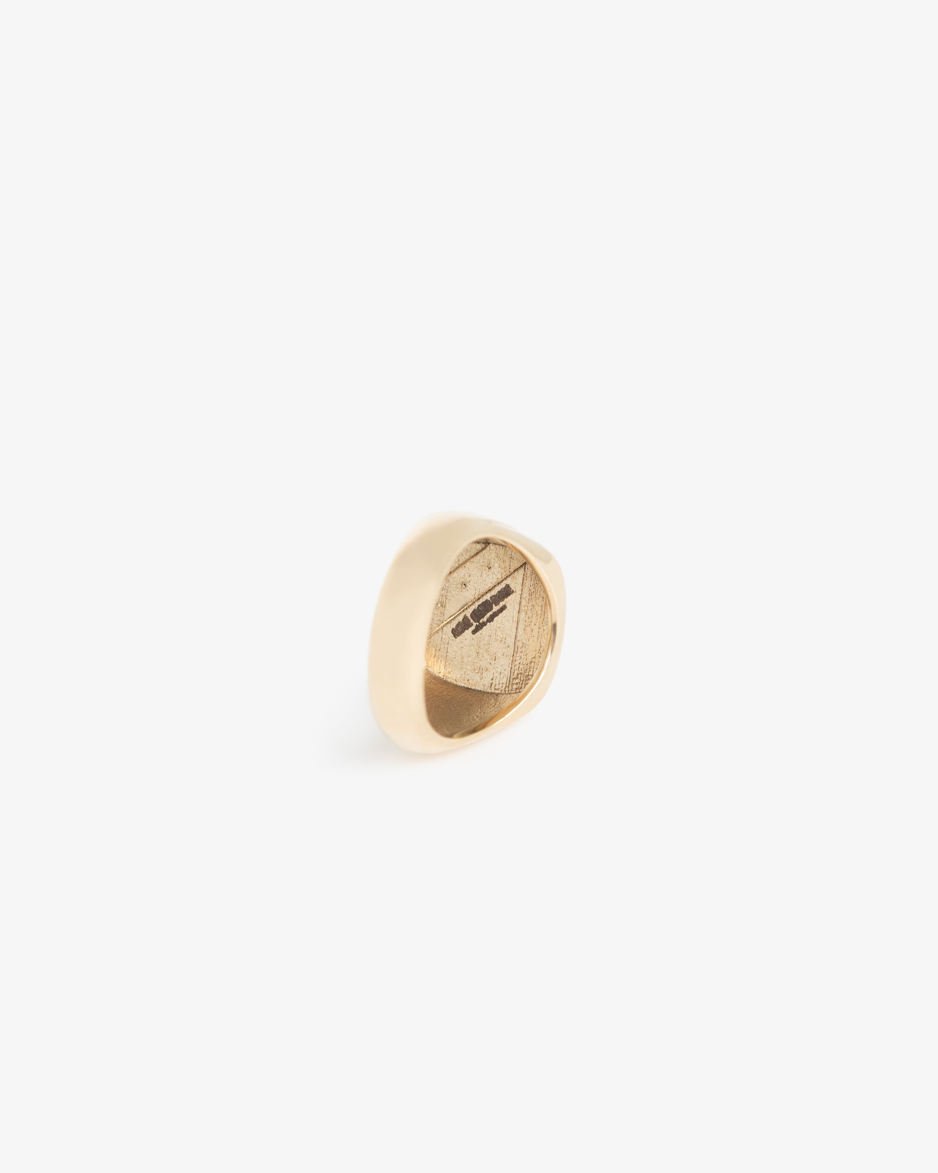 A 14Kt Gold Diamond Signet Ring is shown on a white background, featuring an engraved design on its flat surface.