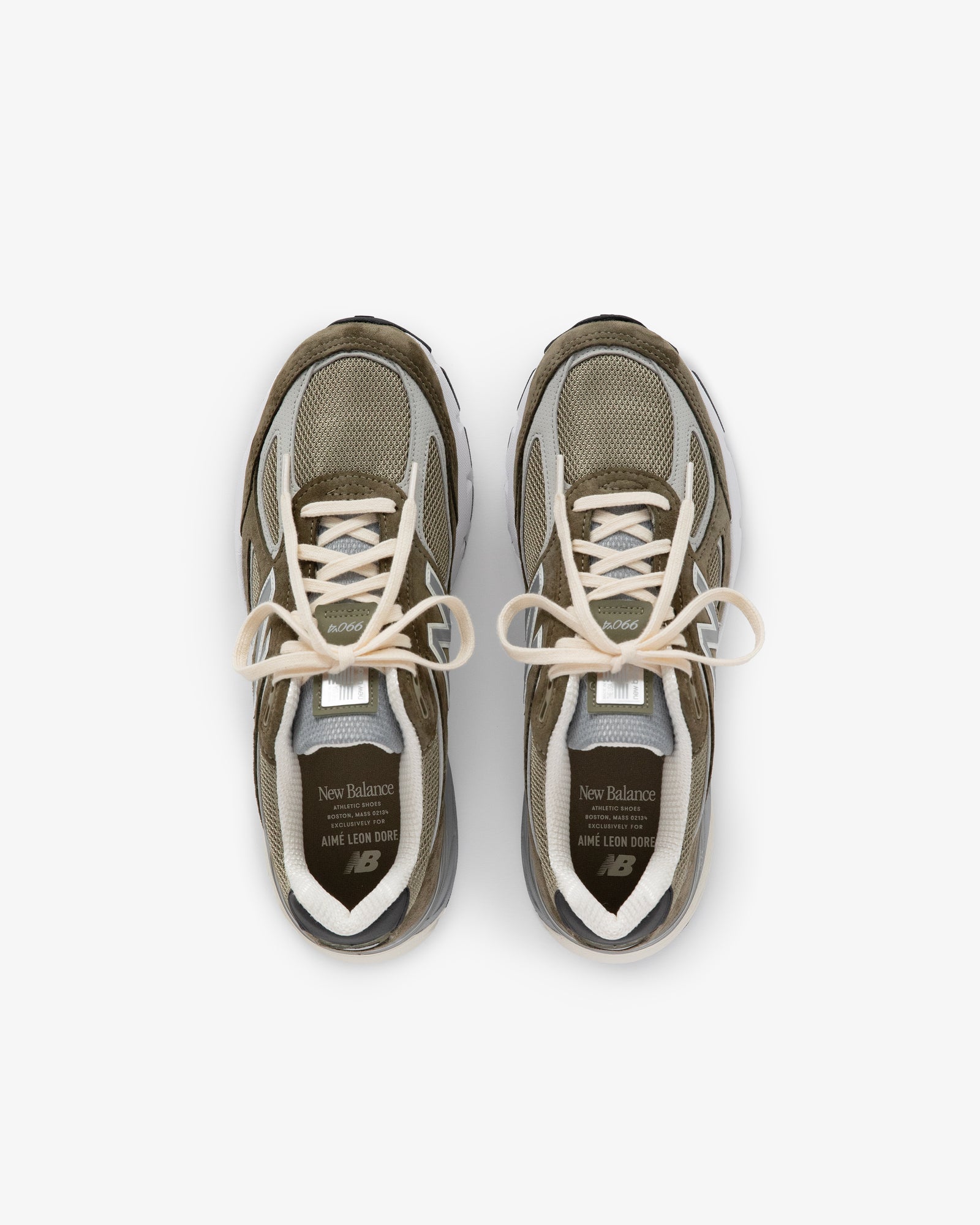 A pair of olive green and beige ALD / New Balance 990v4 sneakers viewed from above on a white background.