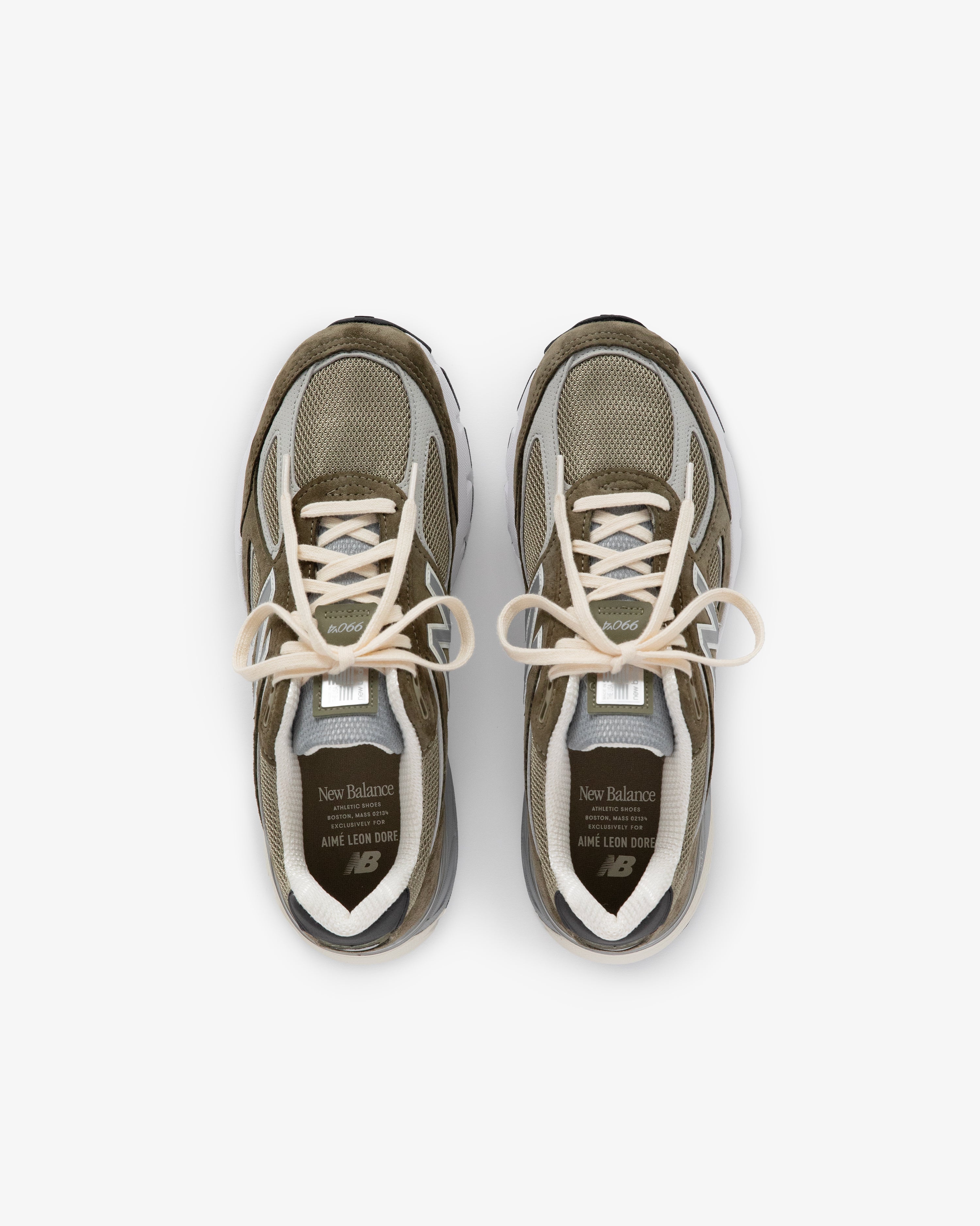 A pair of olive green and beige ALD / New Balance 990v4 sneakers viewed from above on a white background.