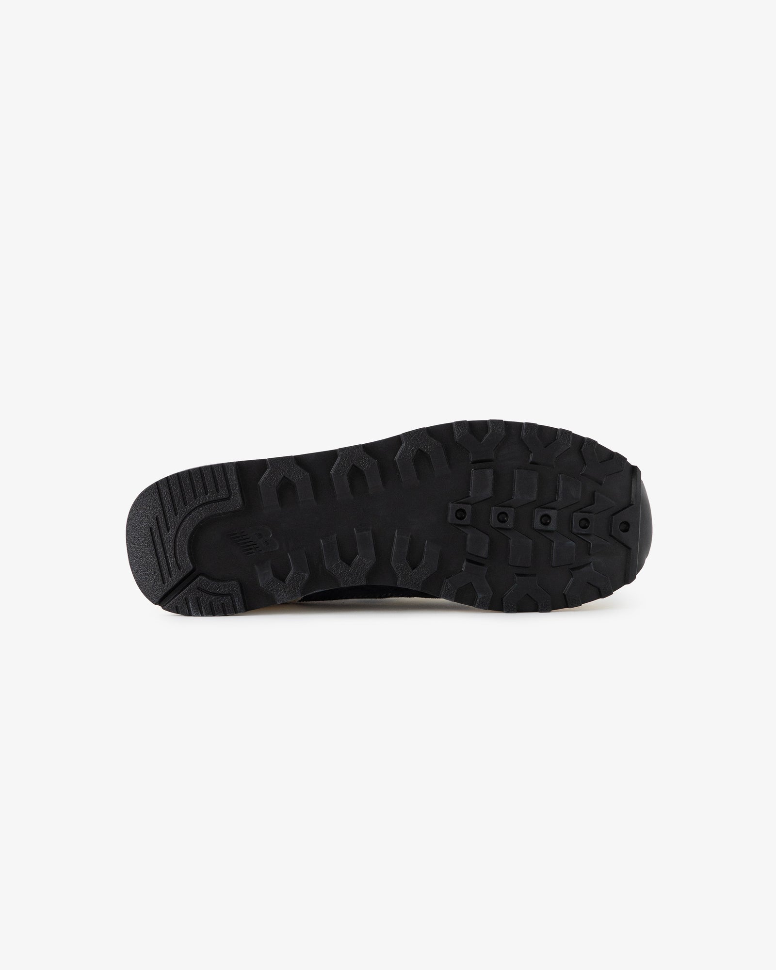 ALD / New Balance 475 black rubber sole with textured tread, shown from the bottom on a white background.