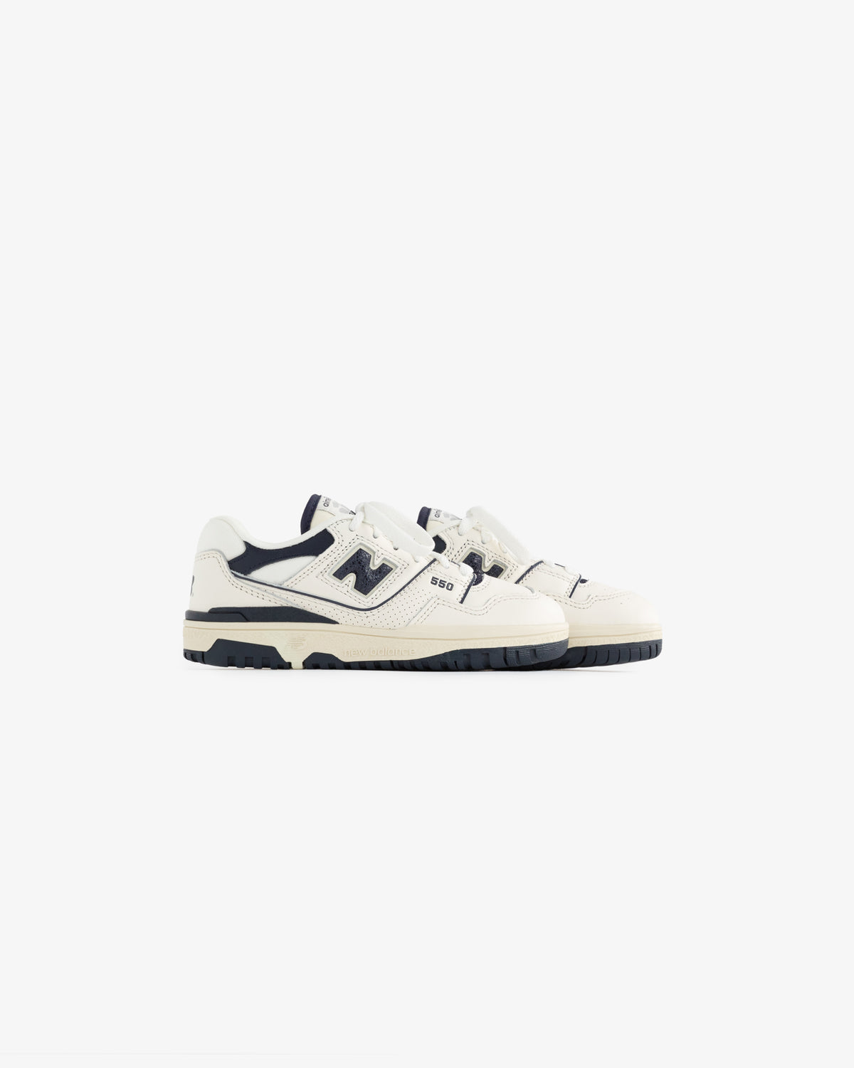 A pair of ALD / NB P550 Basketball Oxfords for little kids in white and navy on a plain white background.