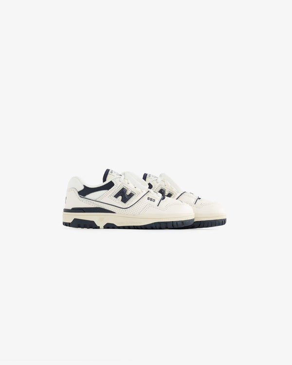 A pair of ALD / NB P550 Basketball Oxfords for little kids in white and navy on a plain white background.