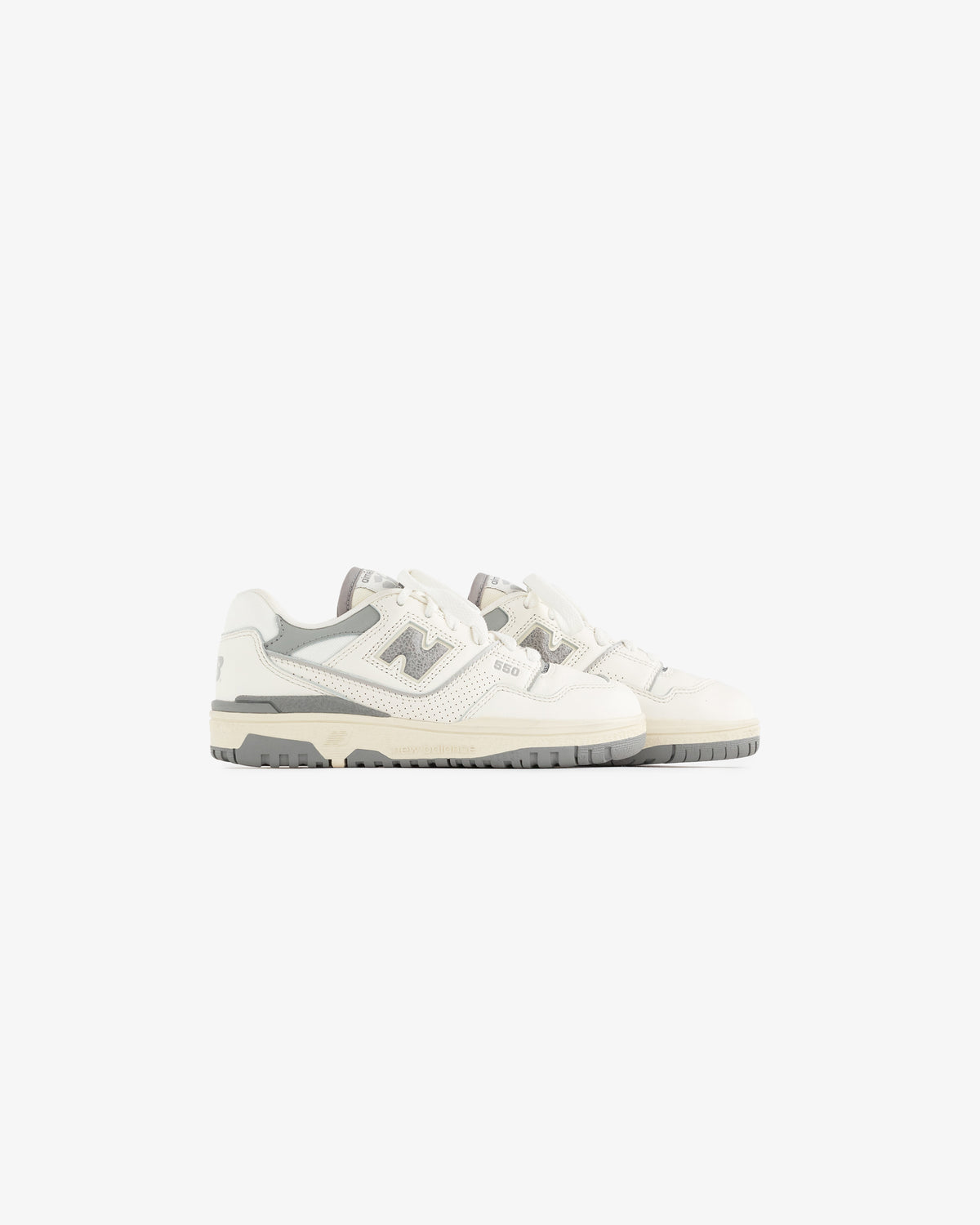 A pair of ALD / NB P550 Basketball Oxfords for little kids in white and light gray on a plain white background.