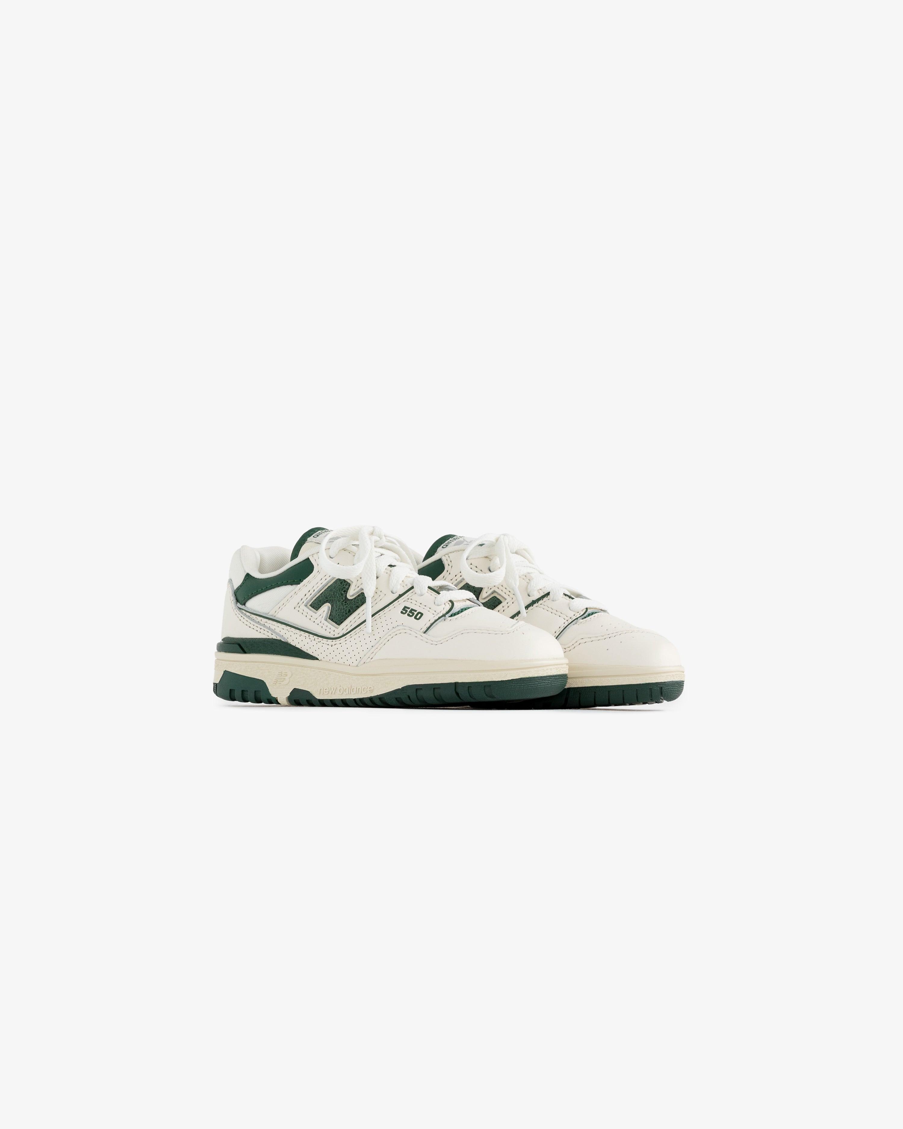 ALD / NB P550 Basketball Oxfords for little kids in white and green, laced, side by side on a white background.