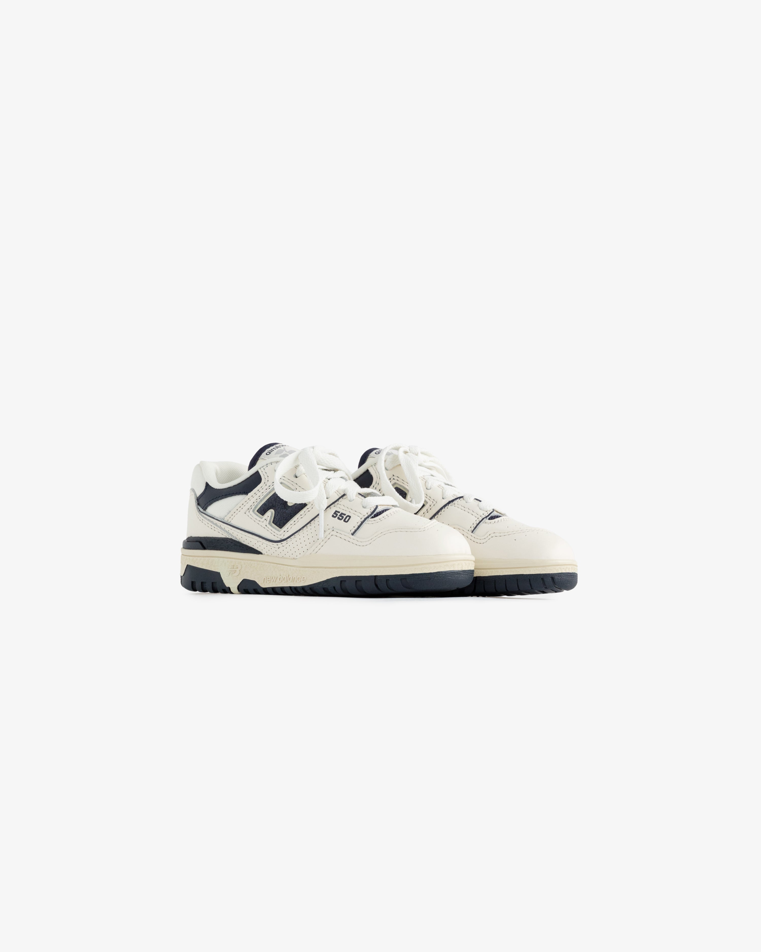 ALD / NB P550 Basketball Oxfords for little kids in white and navy with laces, shown on a plain white background.