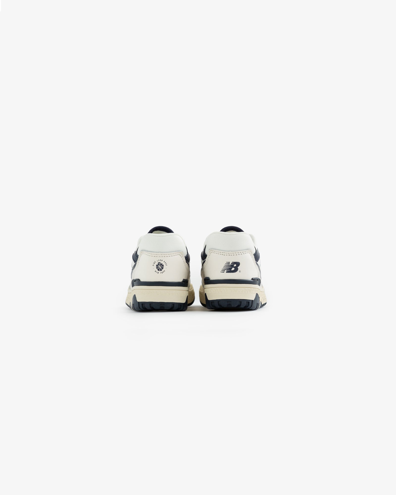 ALD / NB P550 Basketball Oxfords for little kids in white and navy, shown from the back on a plain white background.