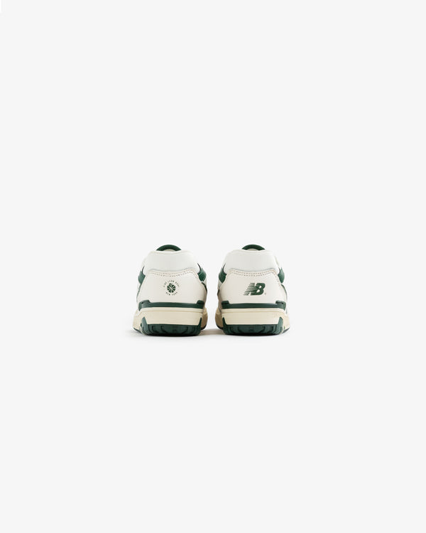 Back view of white and green ALD / NB P550 Basketball Oxfords for little kids on a plain white background.