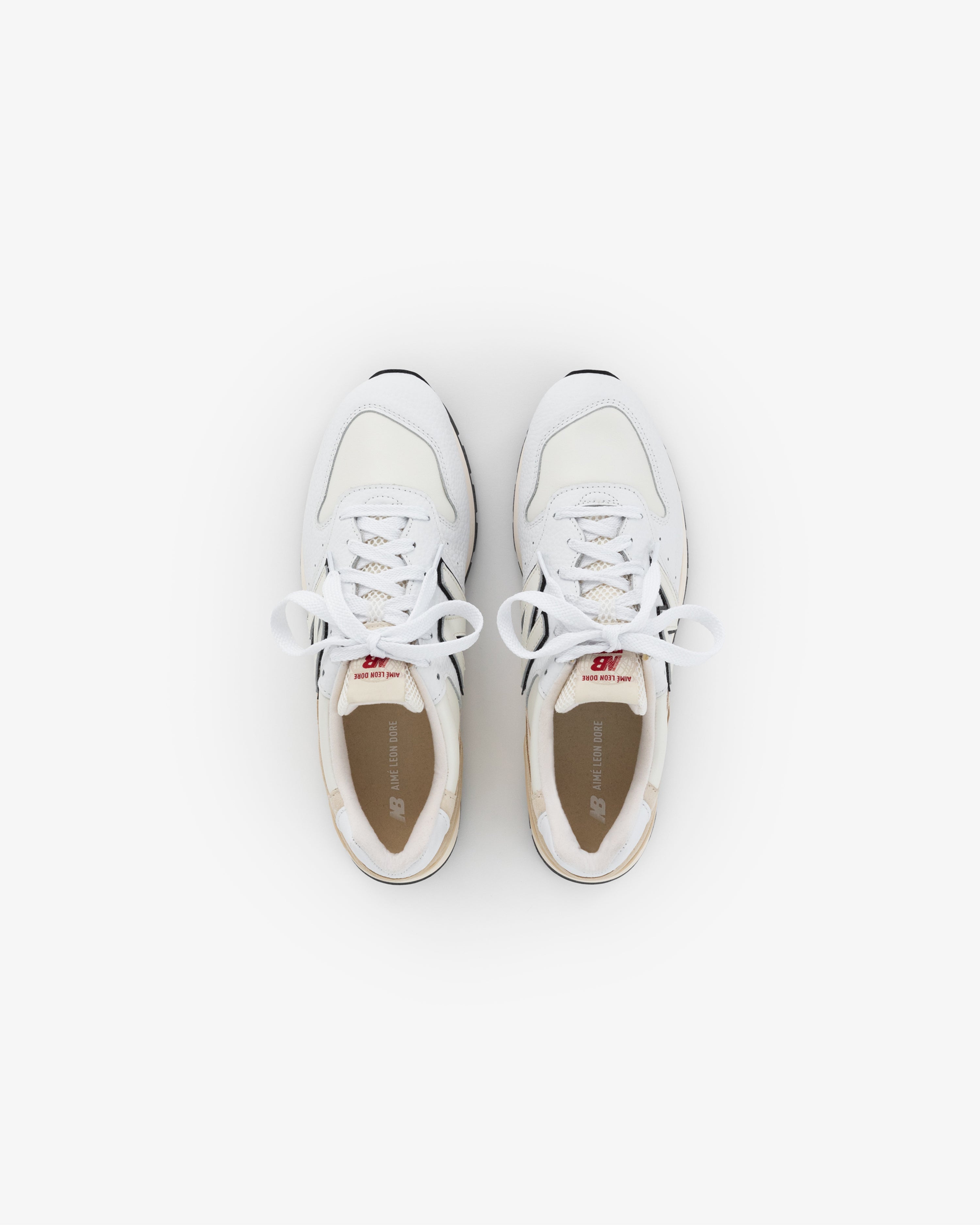 ALD / NB Made in USA 996 white athletic sneakers with laces, viewed from above on a plain white background.