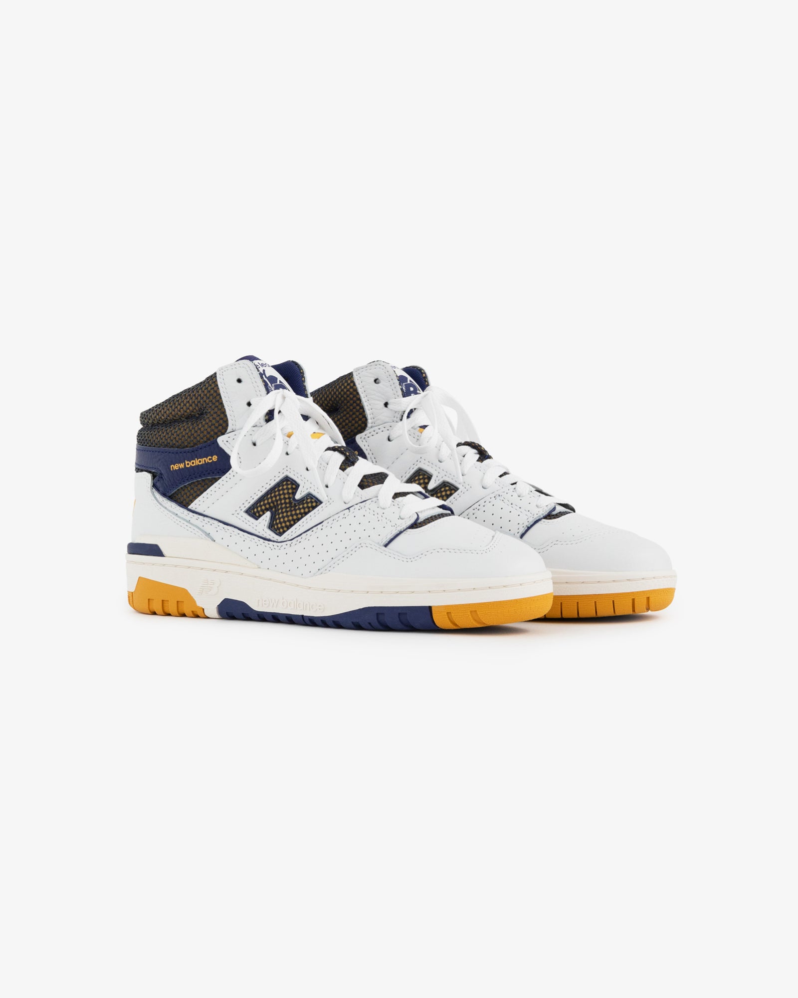The ALD / New Balance 650R is a high-top sneaker in white, navy, and yellow with a perforated toe and mesh accents.