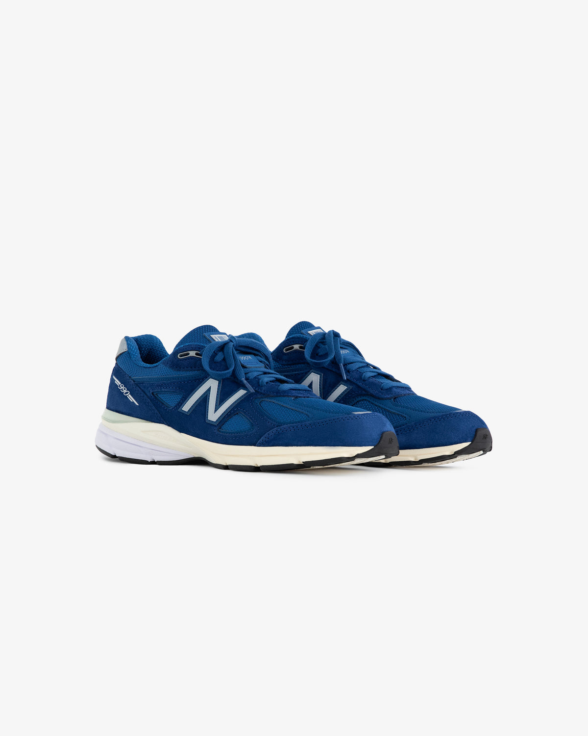 A pair of ALD / NB Made in USA 990v4 sneakers with white soles, viewed at an angle on a white background.