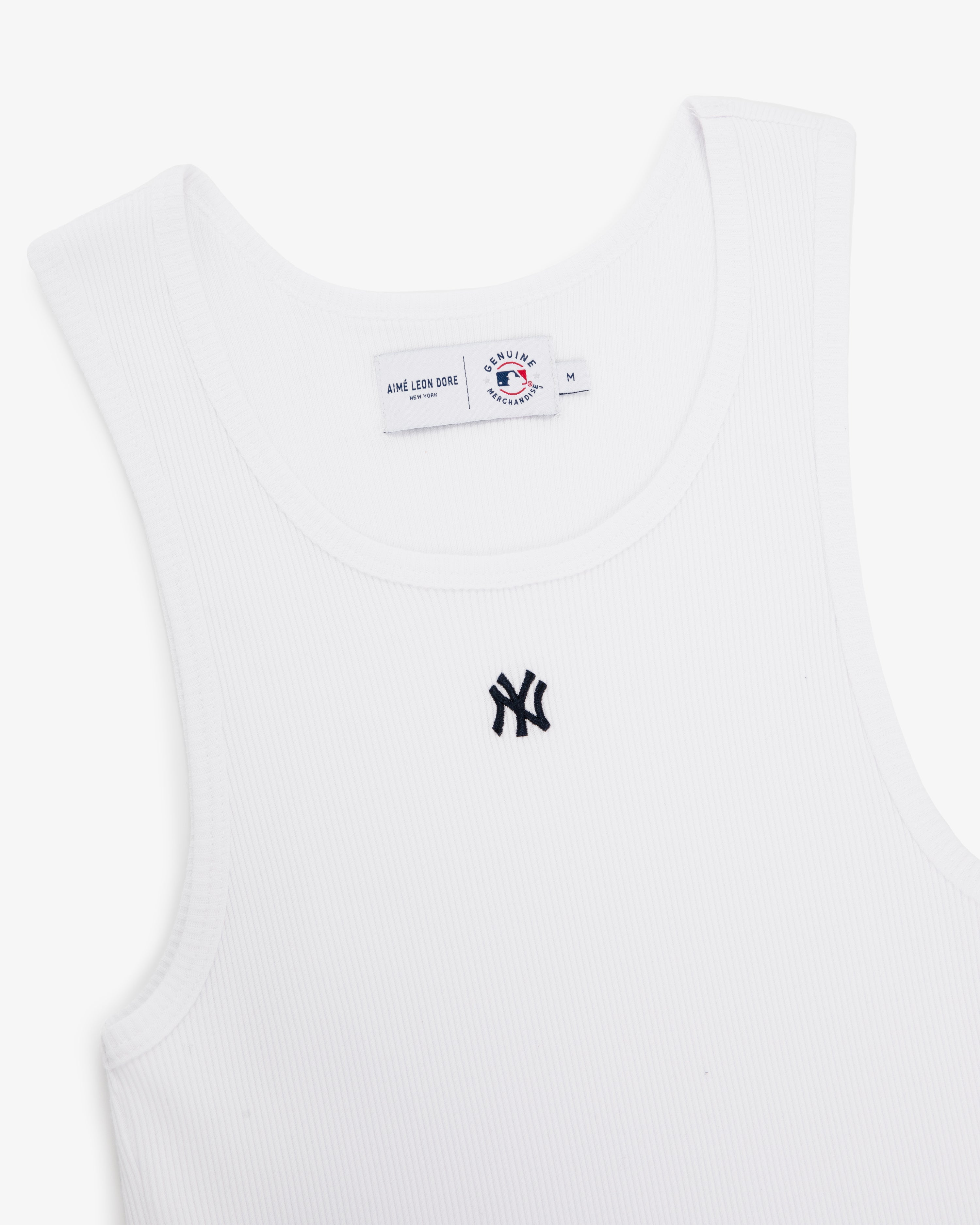 Yankees Tank Top: White ribbed tank with black New York Yankees logo on chest and visible collar tag.