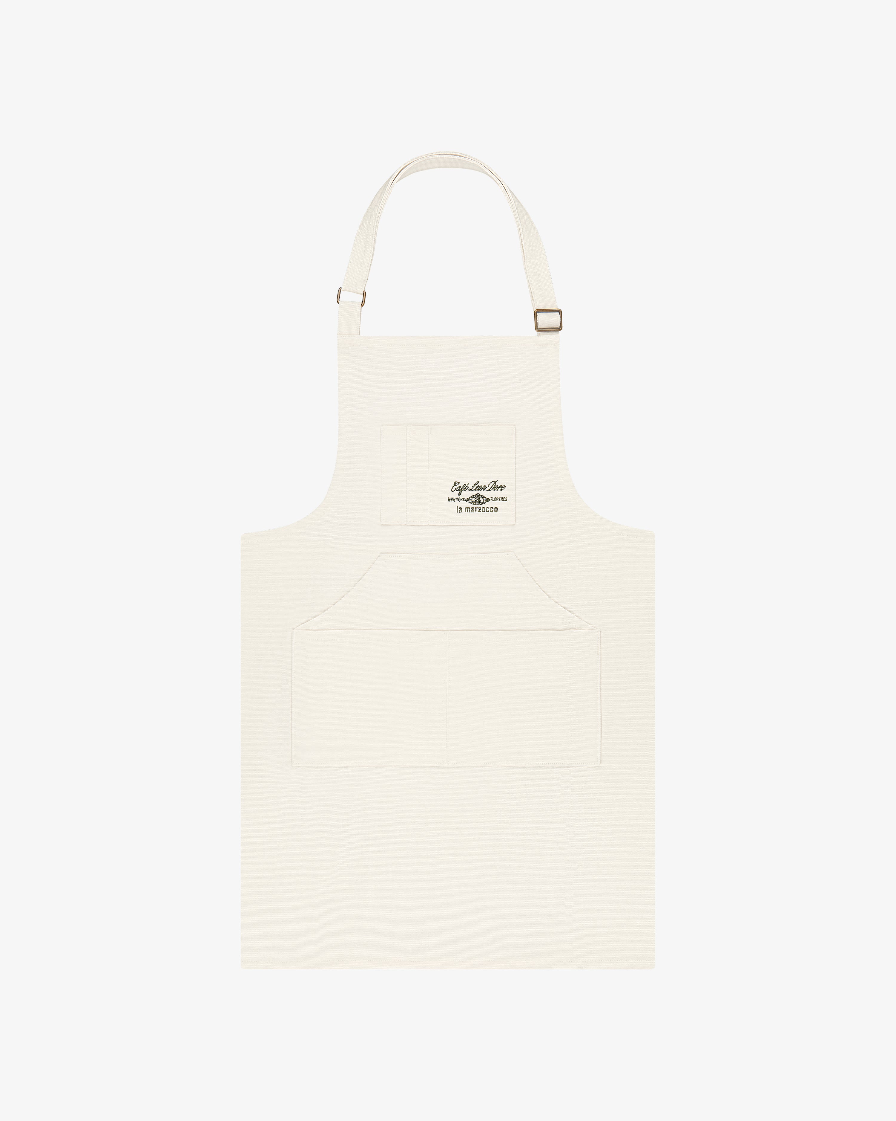 Café Leon Dore / La Marzocco Apron: Ivory with adjustable neck, front pockets, and small chest logo.