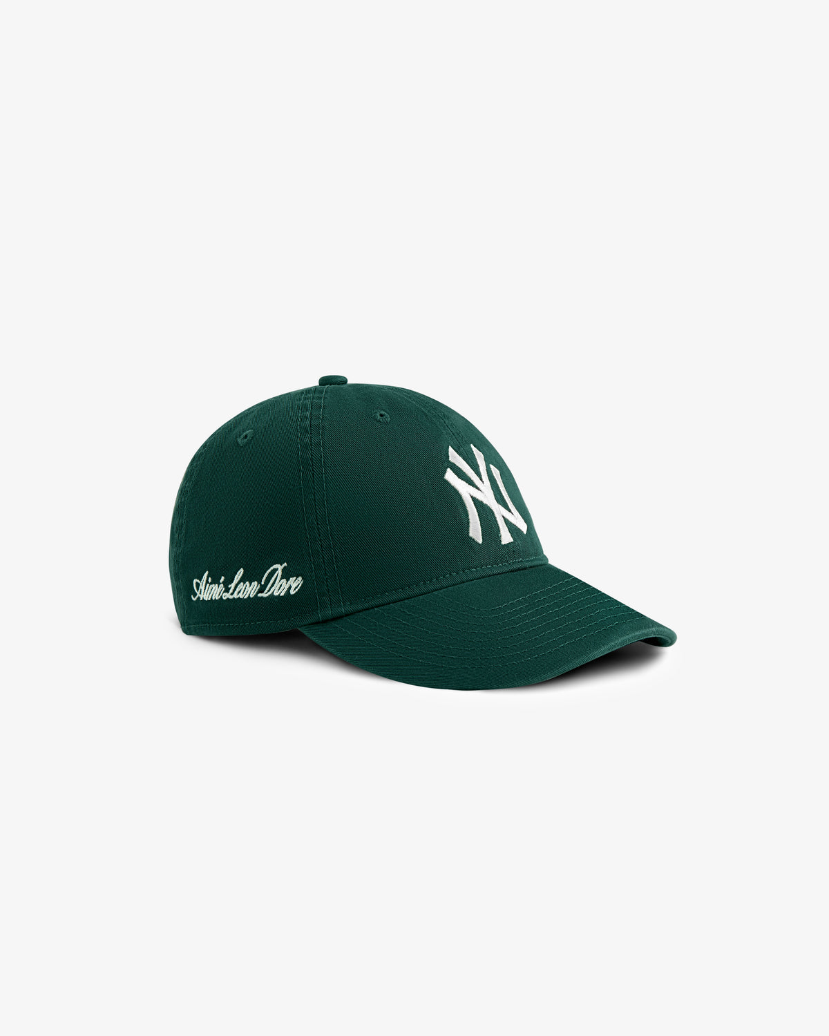 ALD/New Era Yankees Ballpark Hat in dark green with white NY logo front and Saint-Laurent-Dore text on side.