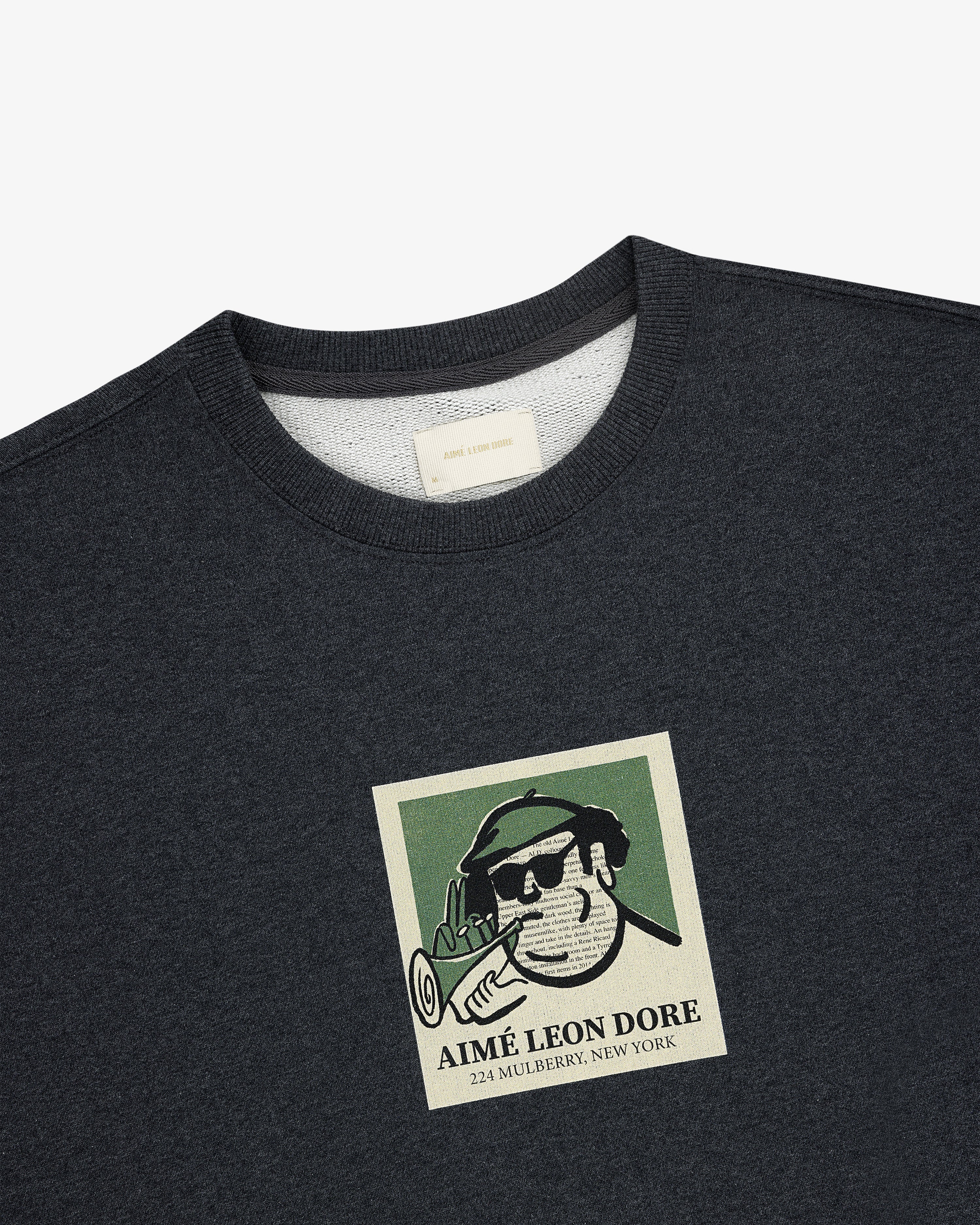 Dark gray Musician Crewneck Sweatshirt featuring a beret-wearing man, pipe, and Aimé Leon Dore, 224 Mulberry, New York.