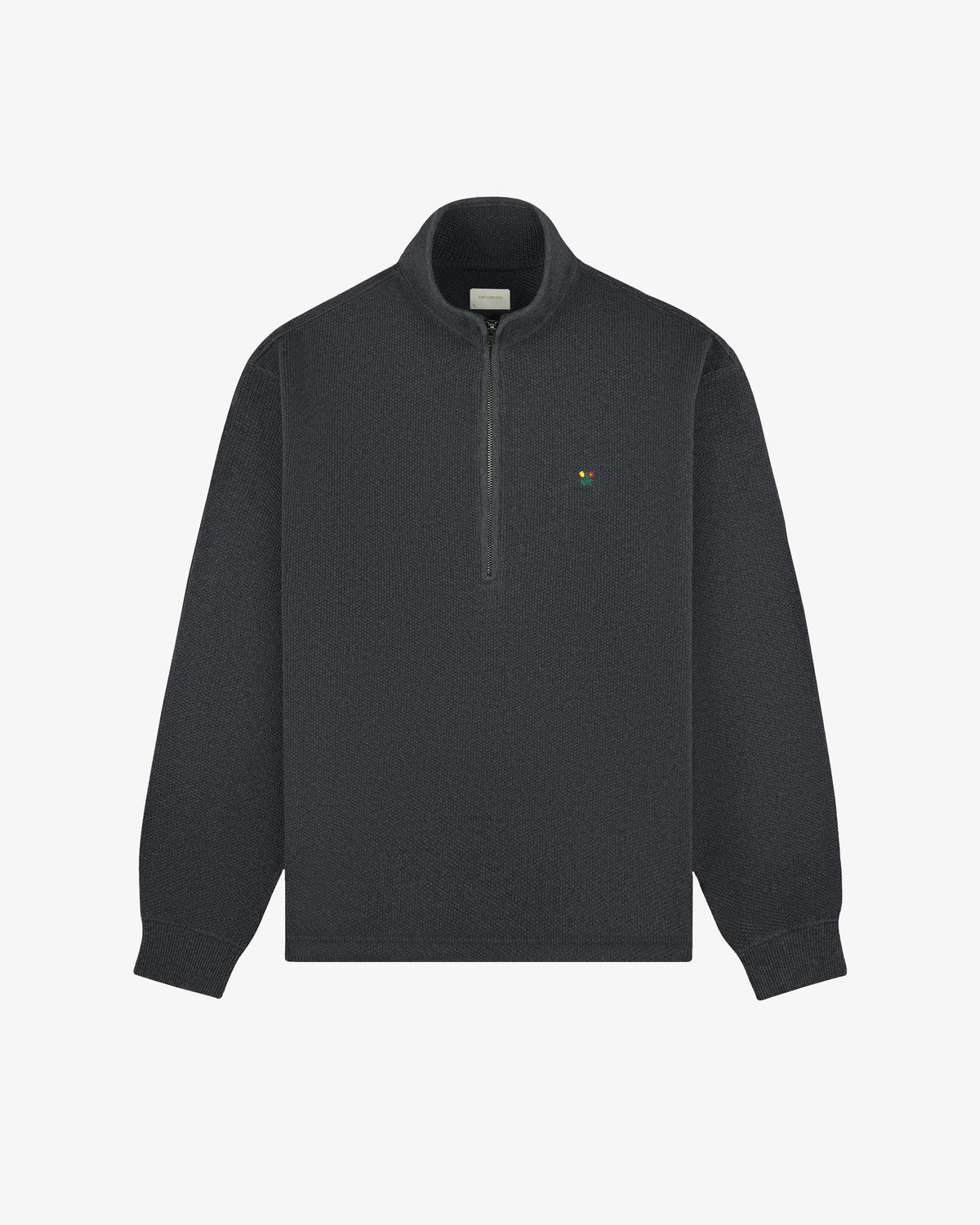 Crest Piqué Half-Zip Pullover in dark gray with a small left chest logo, shown on a plain white background.