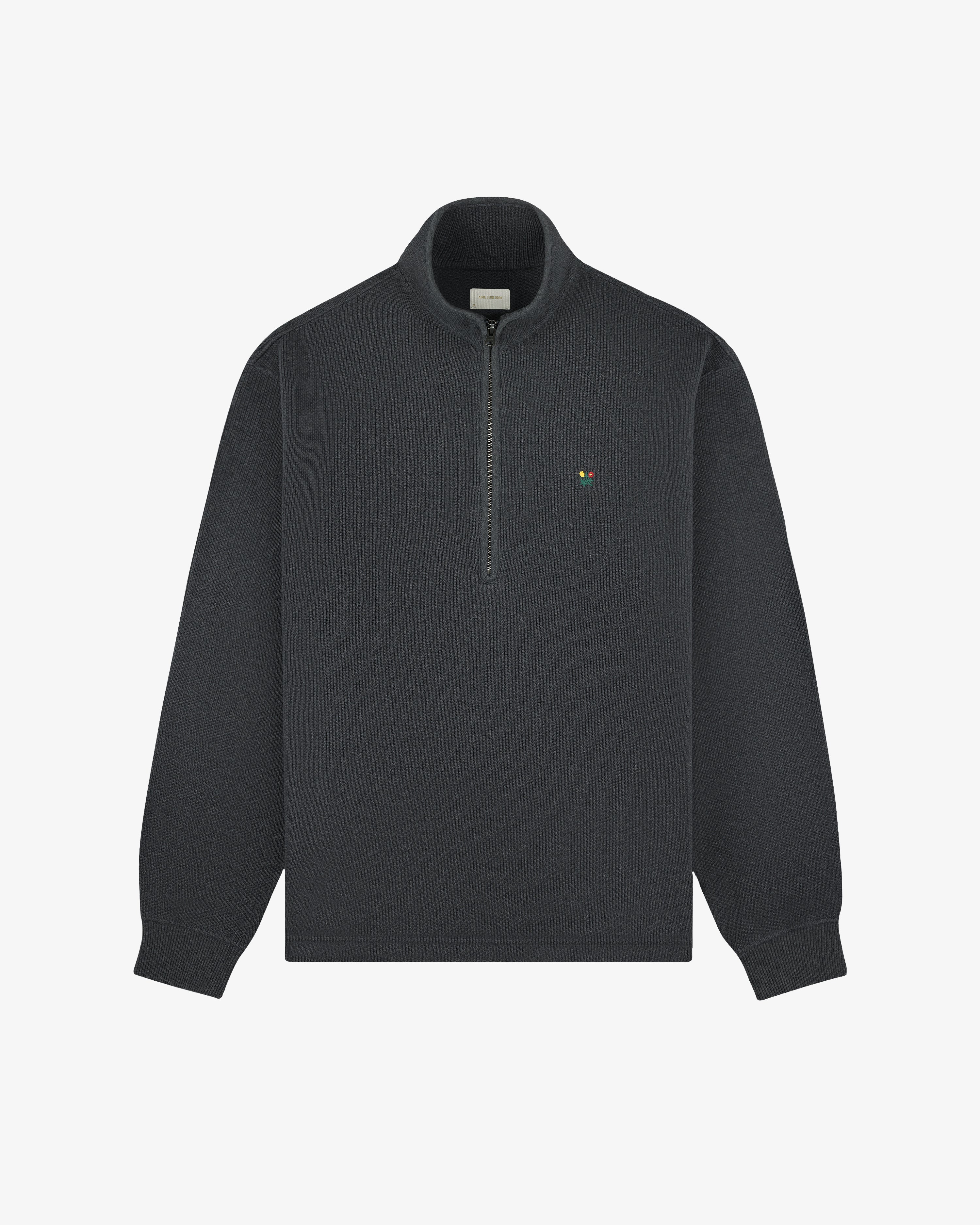 Crest Piqué Half-Zip Pullover in dark gray with a small left chest logo, shown on a plain white background.