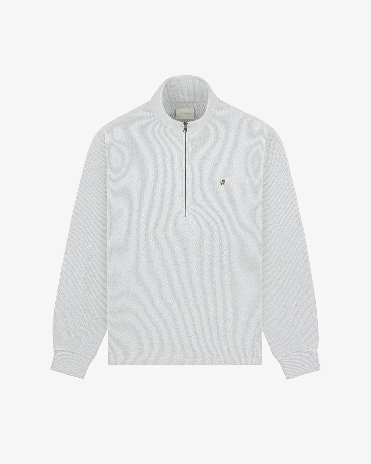 Light gray Crest Piqué Half-Zip Pullover with small embroidered logo on left chest, laid flat on white background.