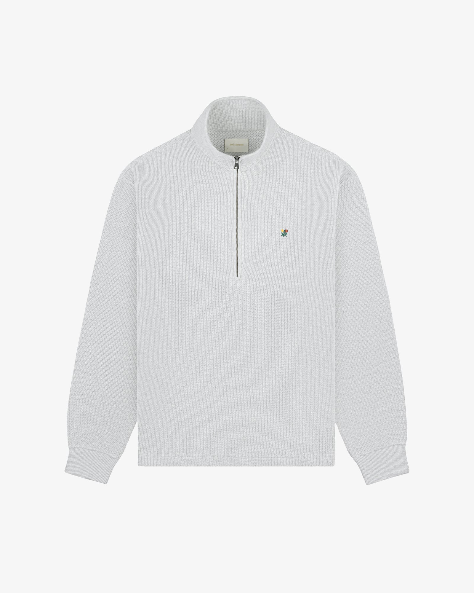 Light gray Crest Piqué Half-Zip Pullover with small embroidered logo on left chest, laid flat on white background.