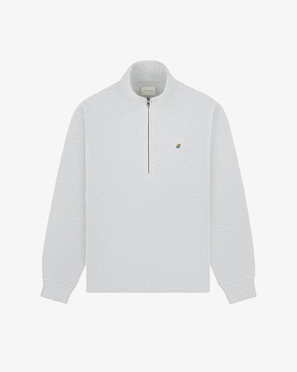 Light gray Crest Piqué Half-Zip Pullover with small embroidered logo on left chest, laid flat on white background.