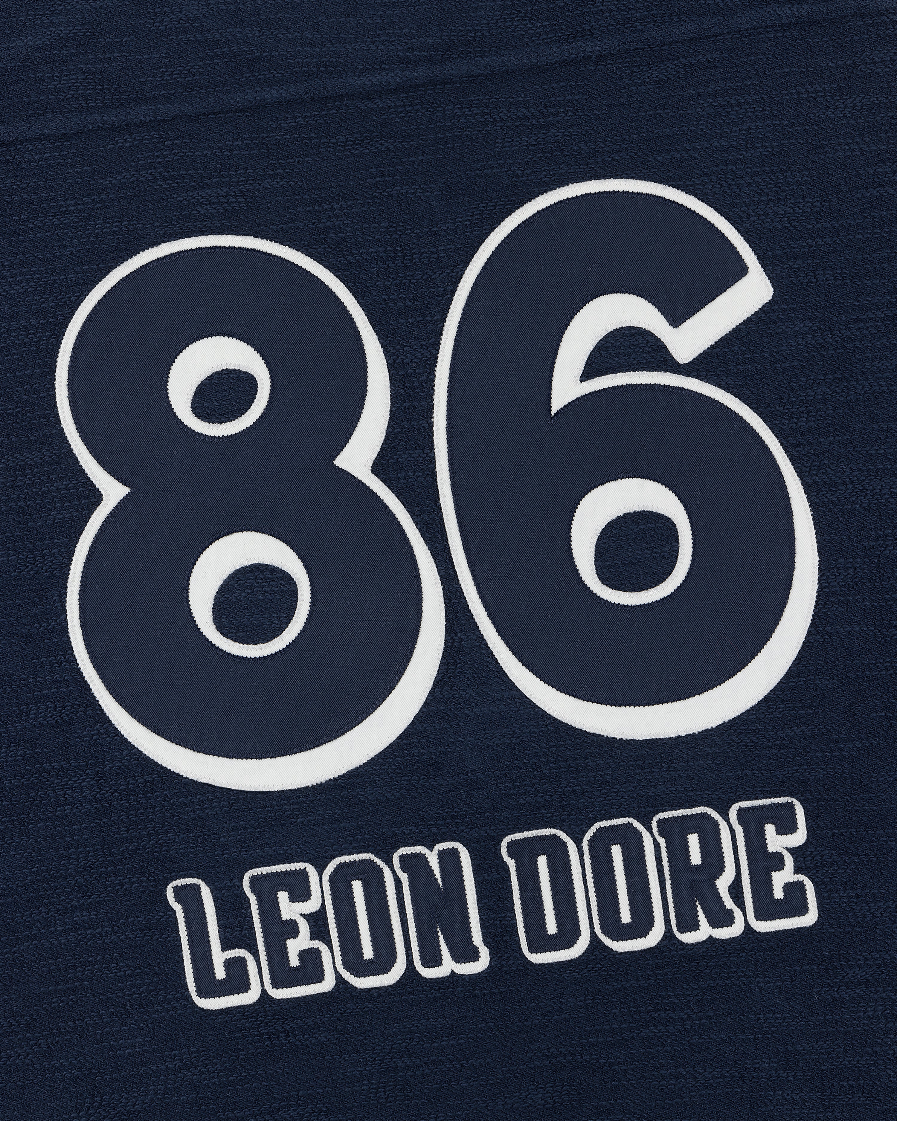 Legacy Slub Football Jersey in dark blue with large white 86 and LEON DORE in white text below.