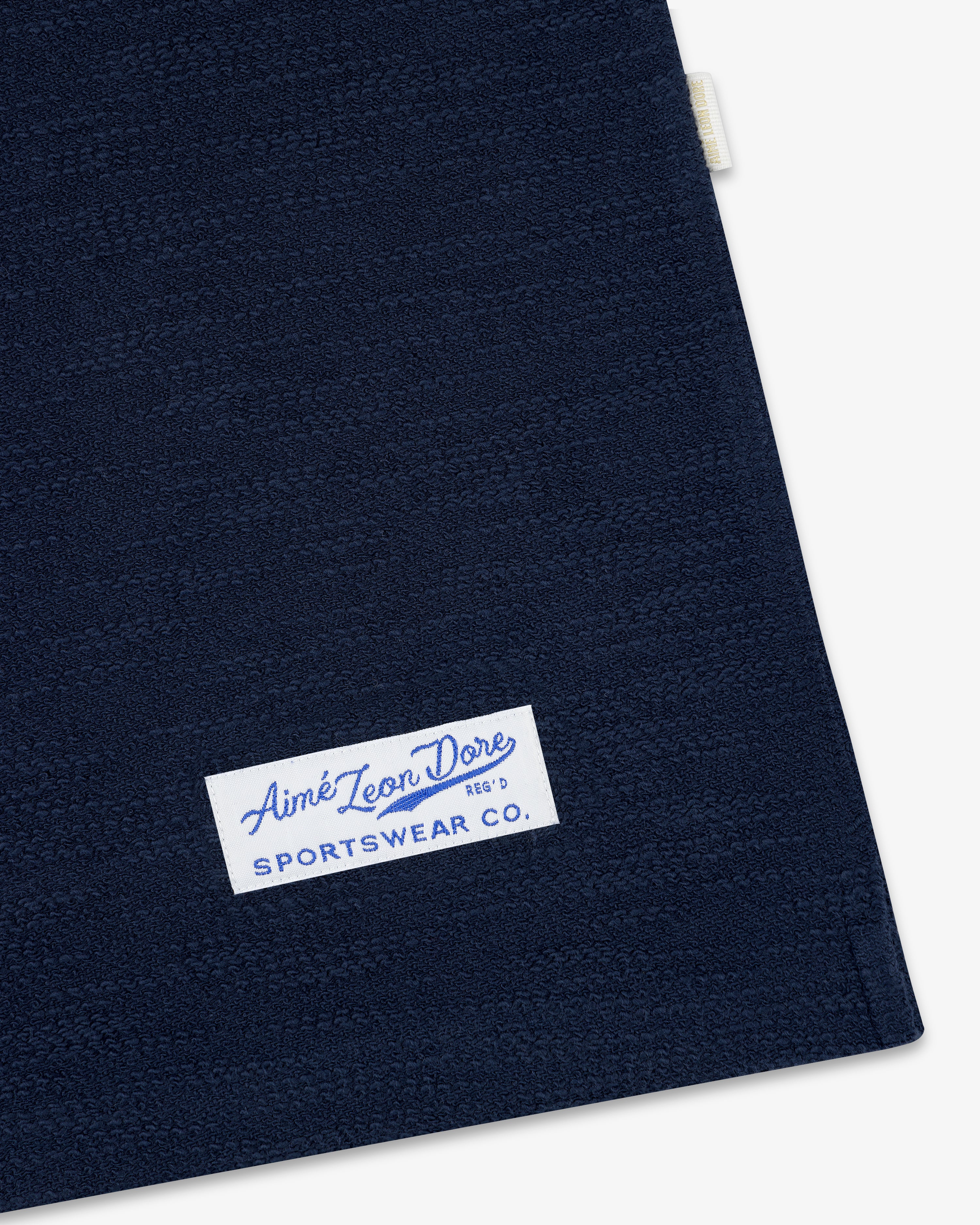 Navy blue Legacy Slub Football Jersey with a white Aimé Leon Dore SPORTSWEAR CO. label in the bottom left.