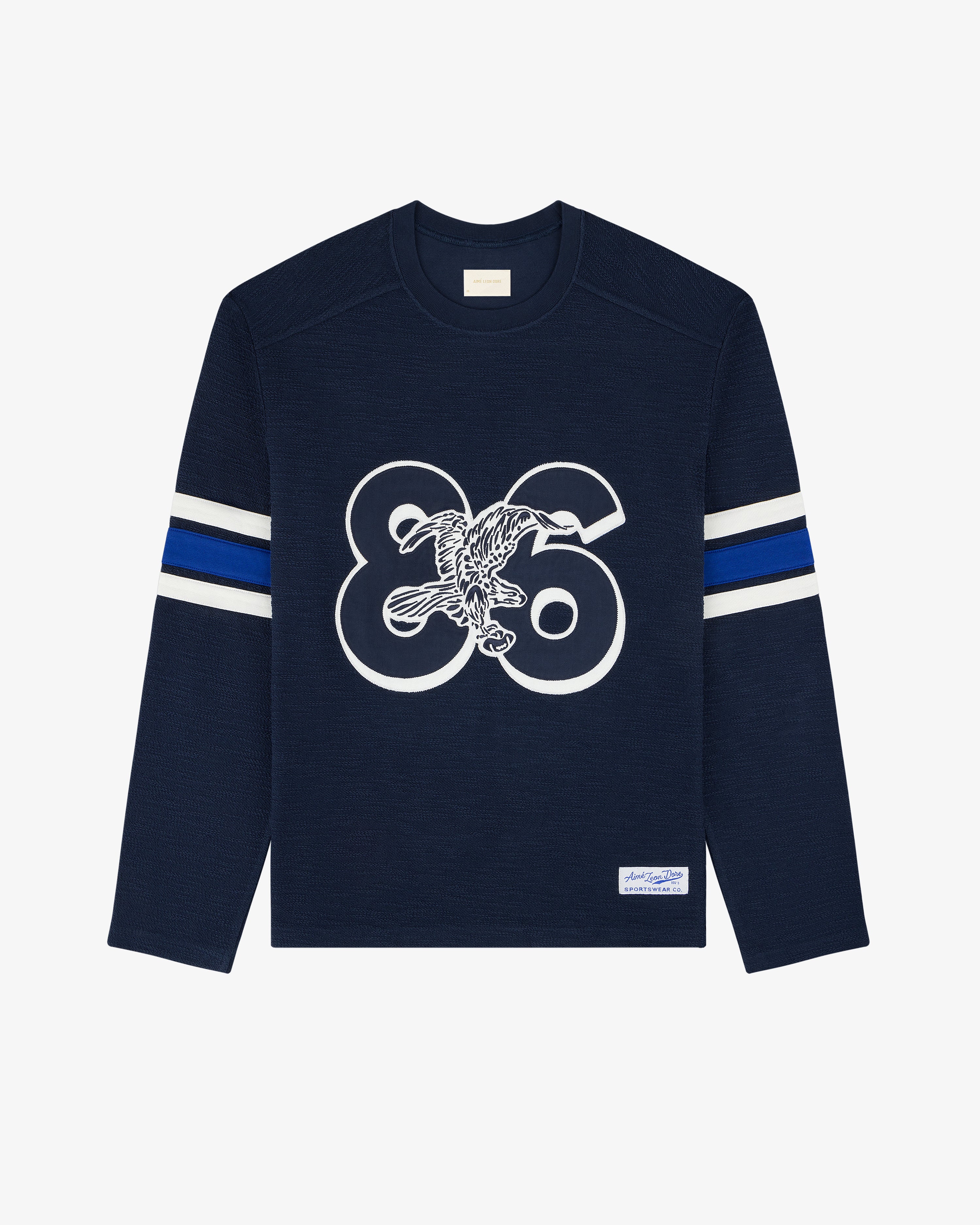 Legacy Slub Football Jersey—navy long-sleeve with white 86, eagle graphic, blue/white stripes, and label detail.