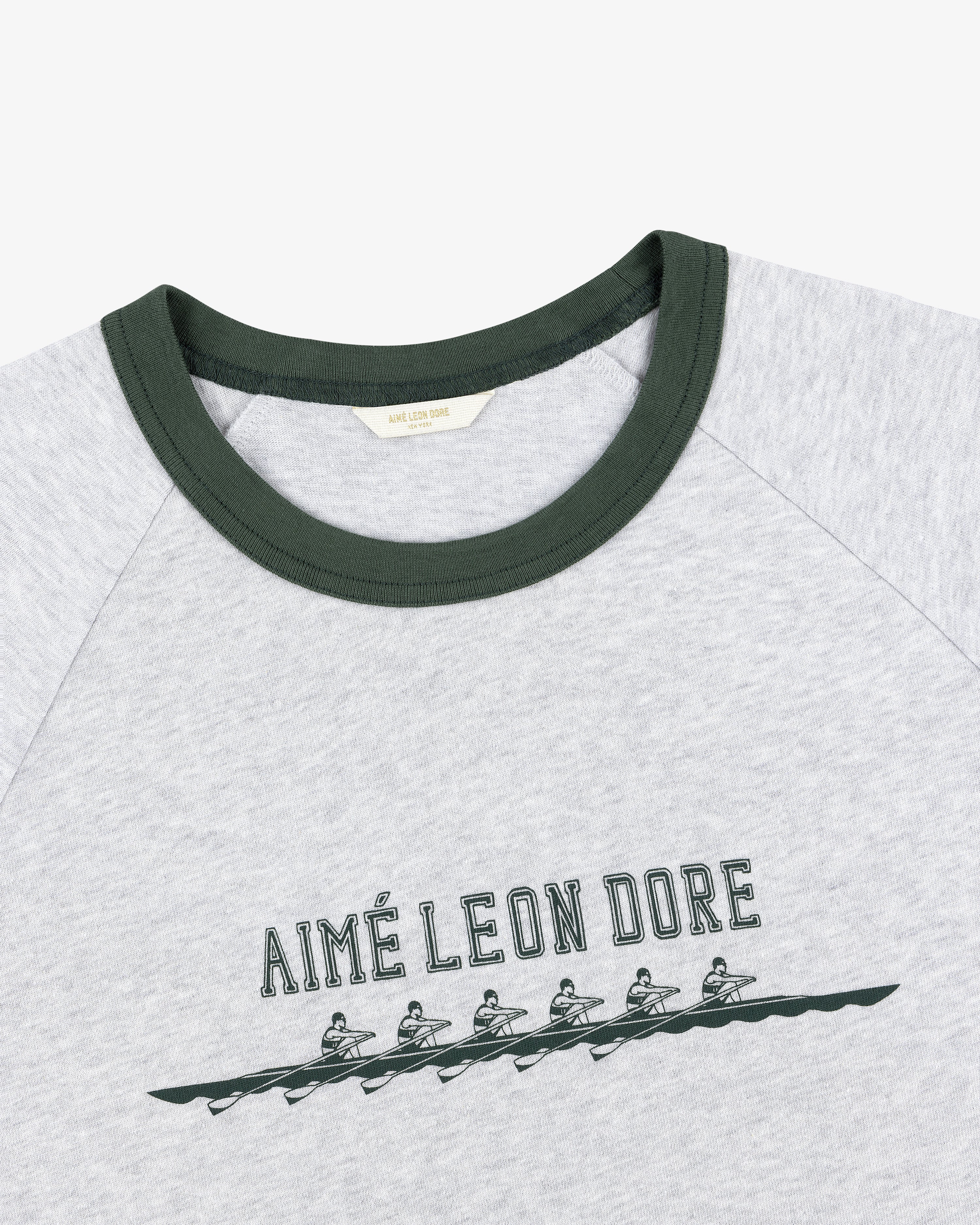 Rowing Tee: Grey shirt with green collar, AIMÉ LEON DORE text, and five rowers graphic below the text.