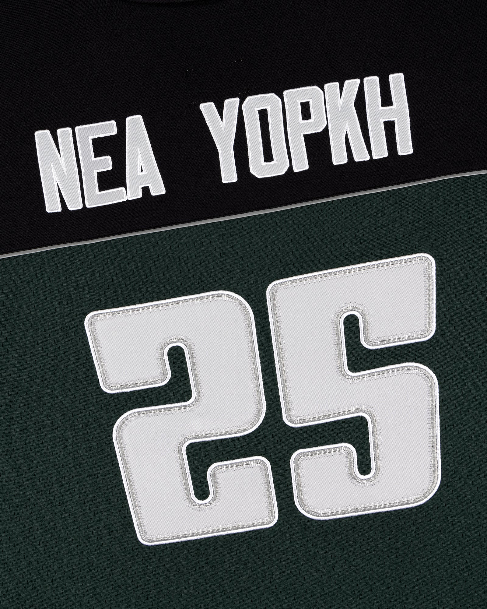 ALD / Mitchell & Ness black and green jersey with “NEA YOPKH” and a bold number 25 on the front.