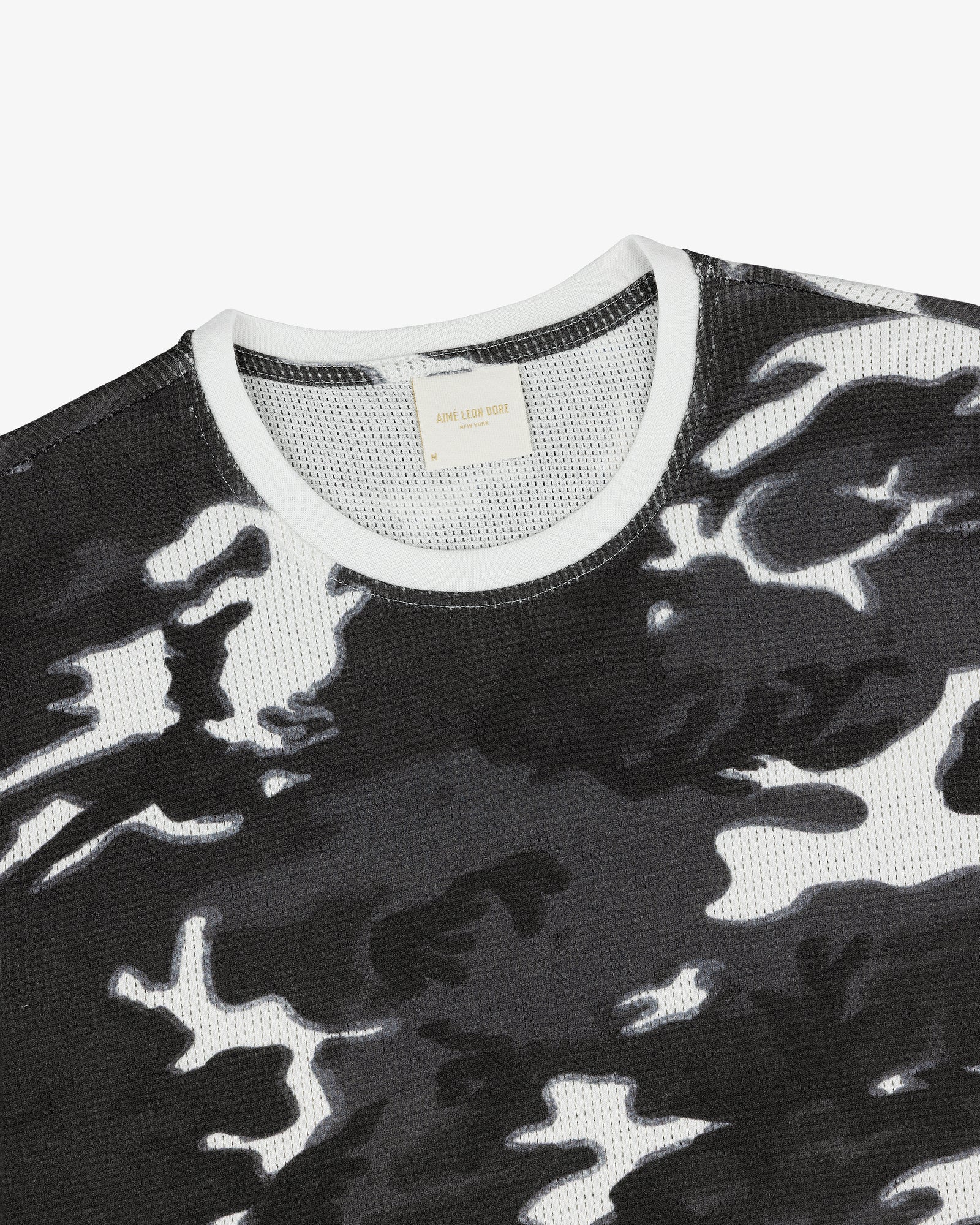 Printed Mesh Moto Tee in black and white camo with a white ribbed collar on a plain background.