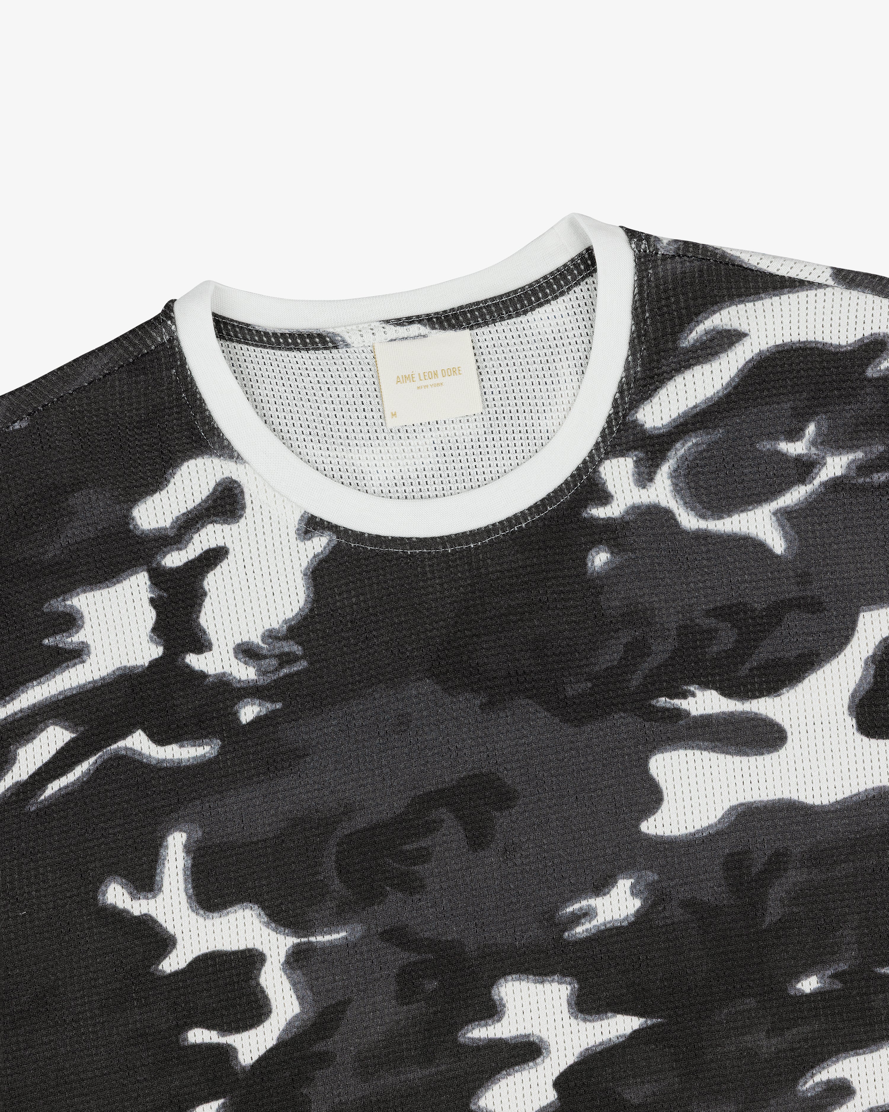 Printed Mesh Moto Tee in black and white camo with a white ribbed collar on a plain background.