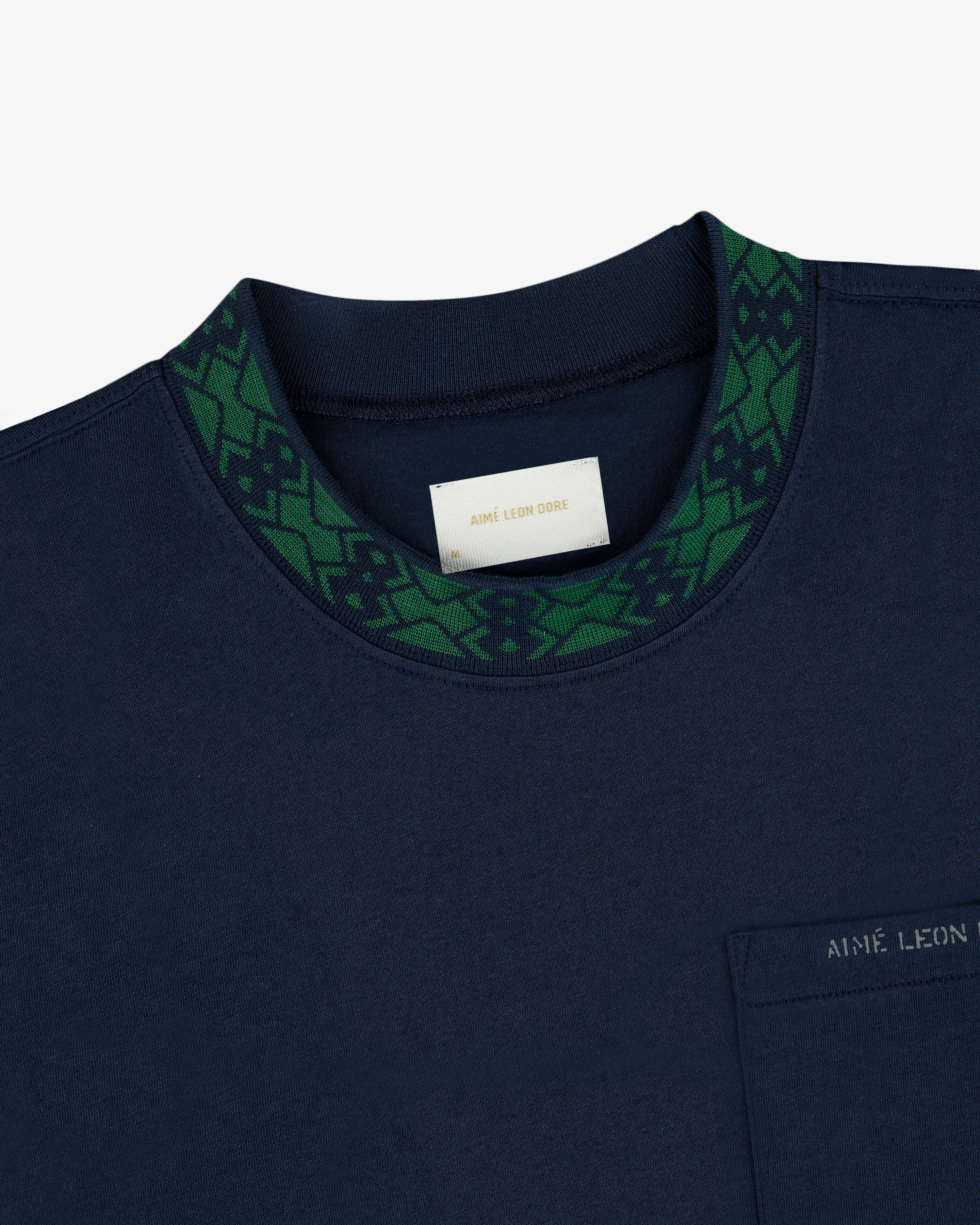 Navy Jacquard Collar Pocket Tee with green geometric collar, chest pocket, label: AIME LEON DORE.