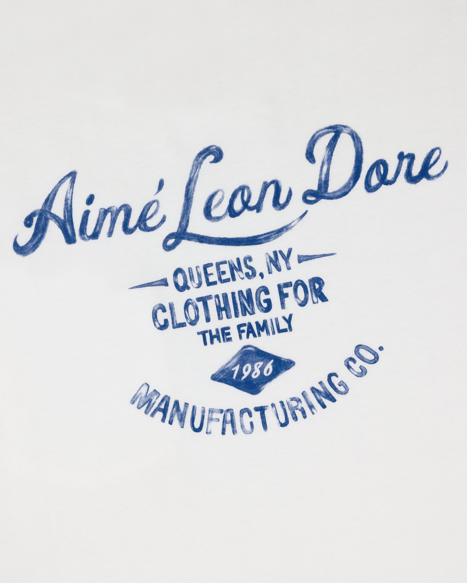 Blue script text reads General Store Pocket Tee on white fabric.