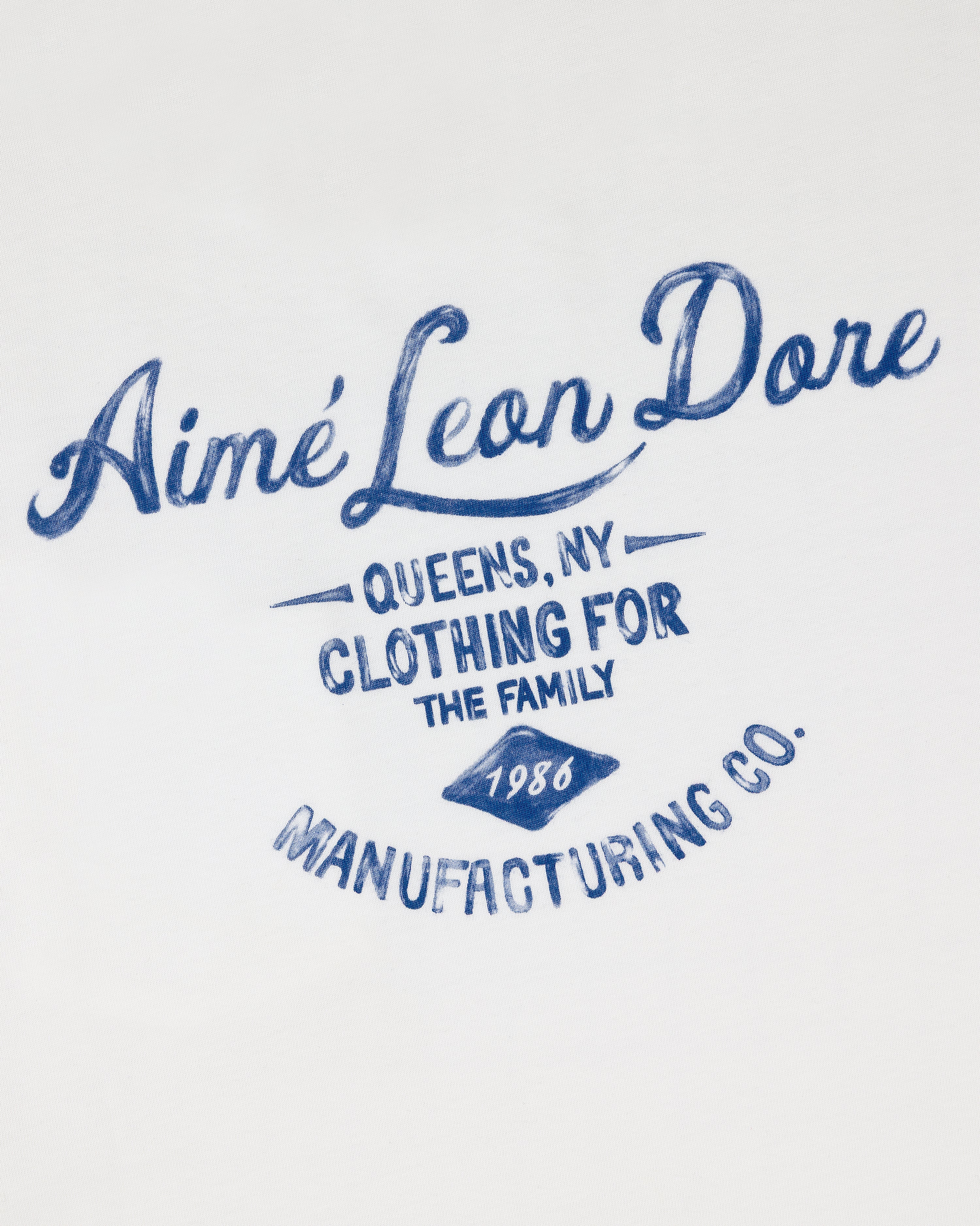 Blue script text reads General Store Pocket Tee on white fabric.